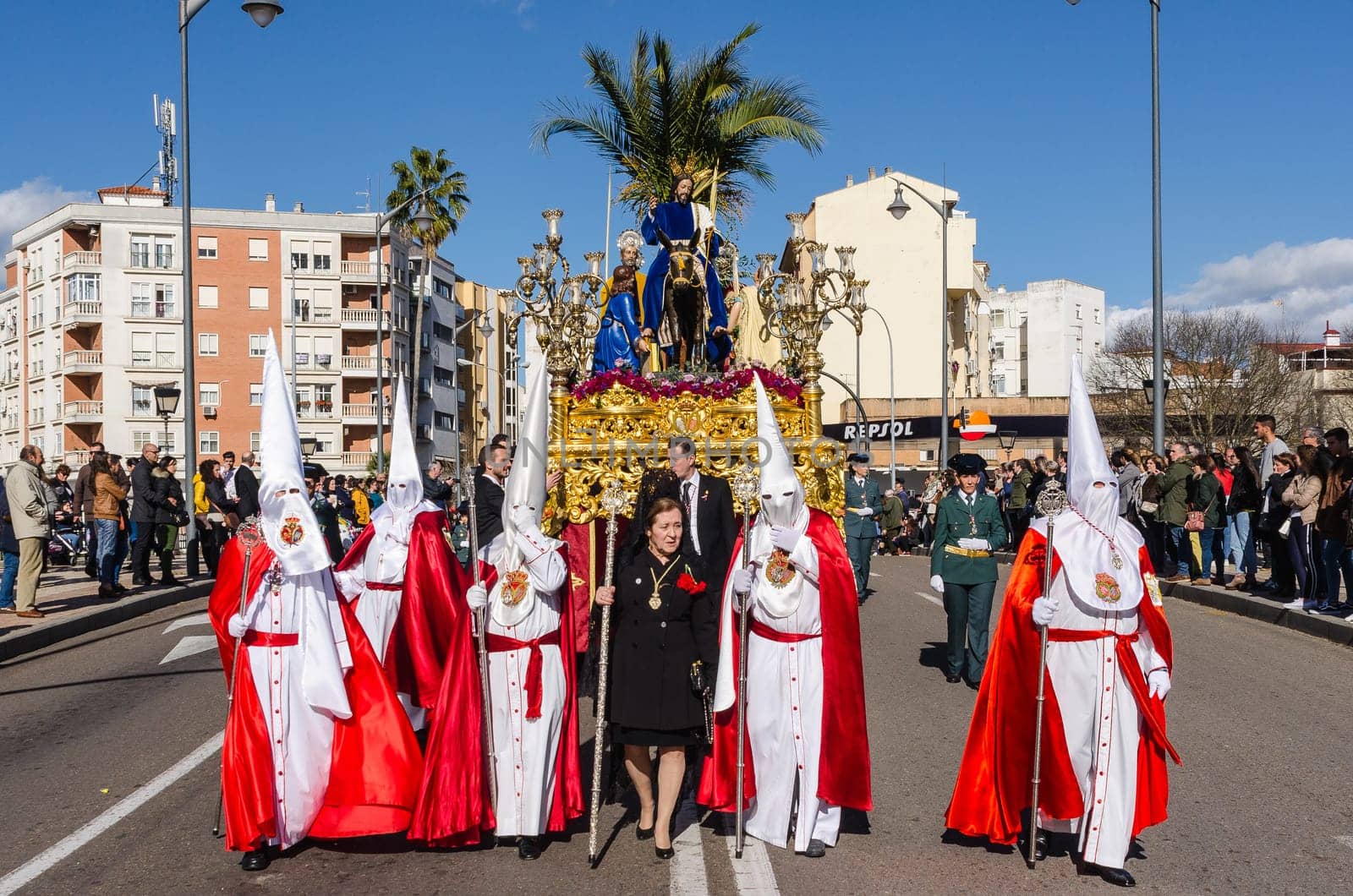 BADAJOZ, SPAIN - MARCH 26, 2018: Nazarenes and Jesus riding a donkey, during the celebration of Palm Sunday.