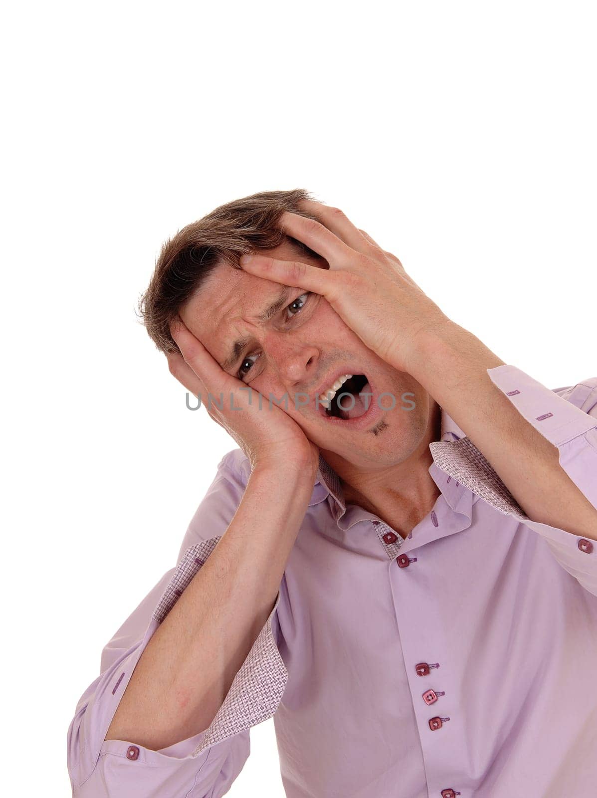A young man with his hands on his face crying for pain with his head.to the side and mouth open, isolated for white background.