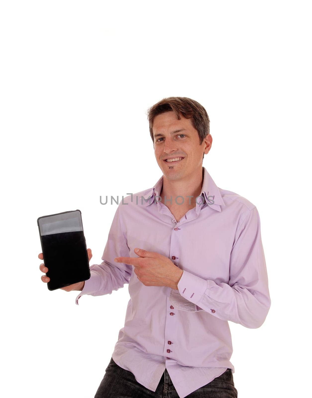 A smiling man sitting and pointing with his finger at his new tablet.is proud what he sees, isolated for white background.