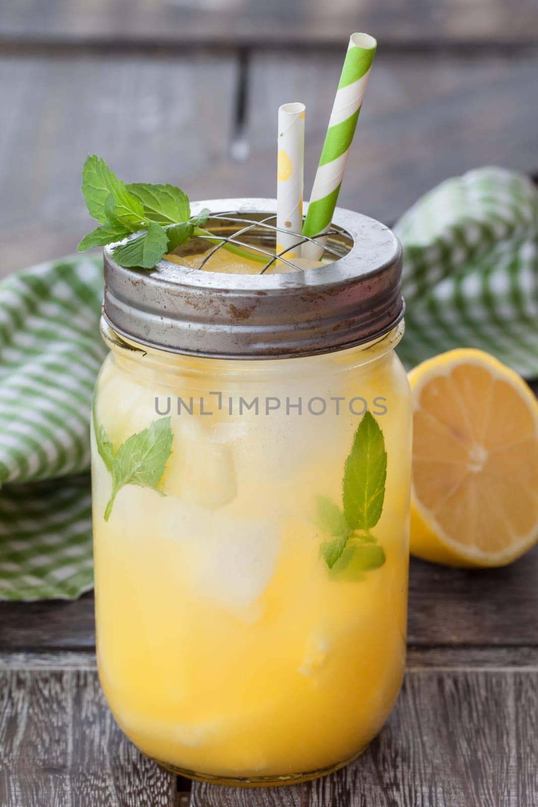 Rustic mason jar with lemonade with fresh pineapple