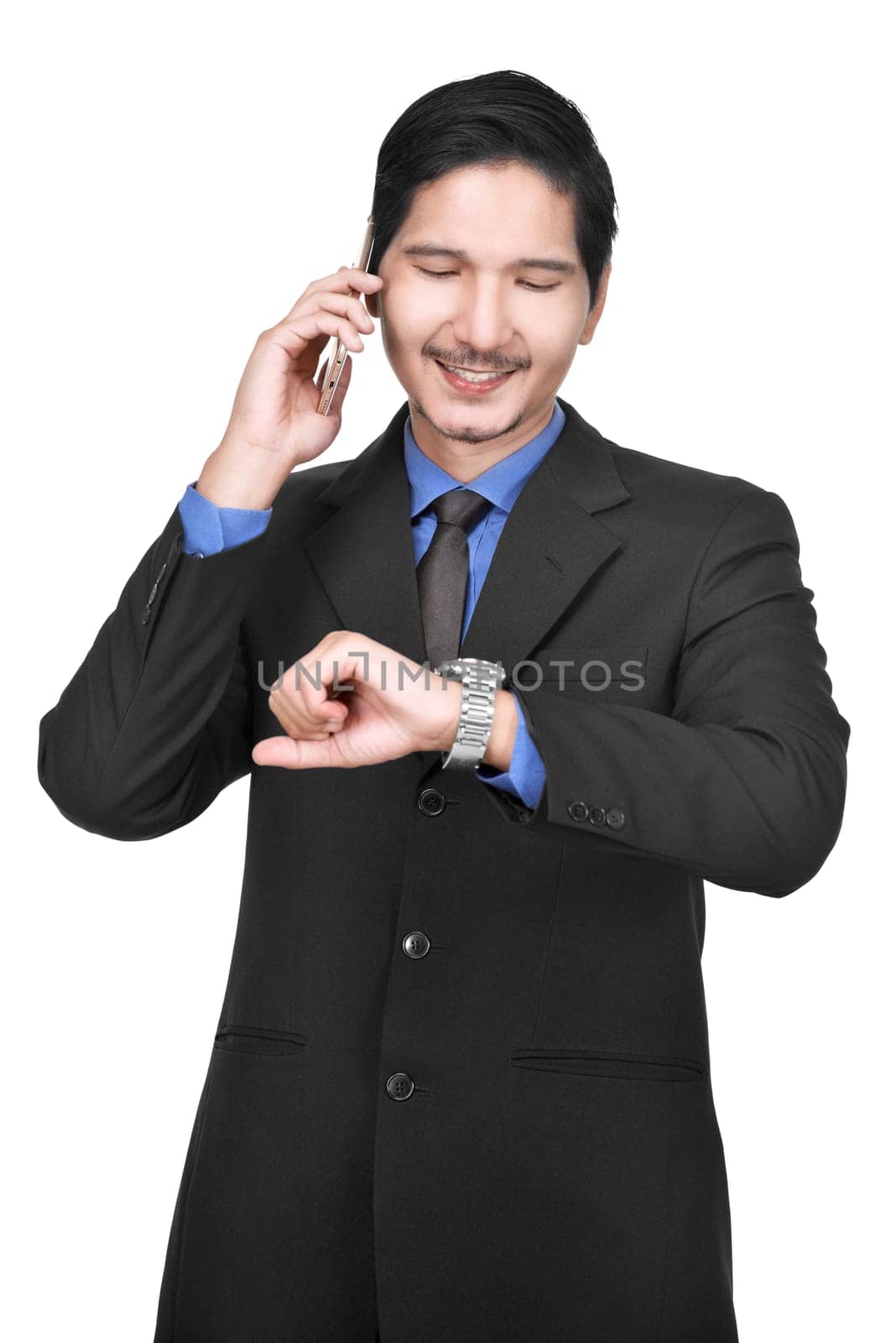 Image of asian businessman with cellphone while looking at watch posing isolated over white background