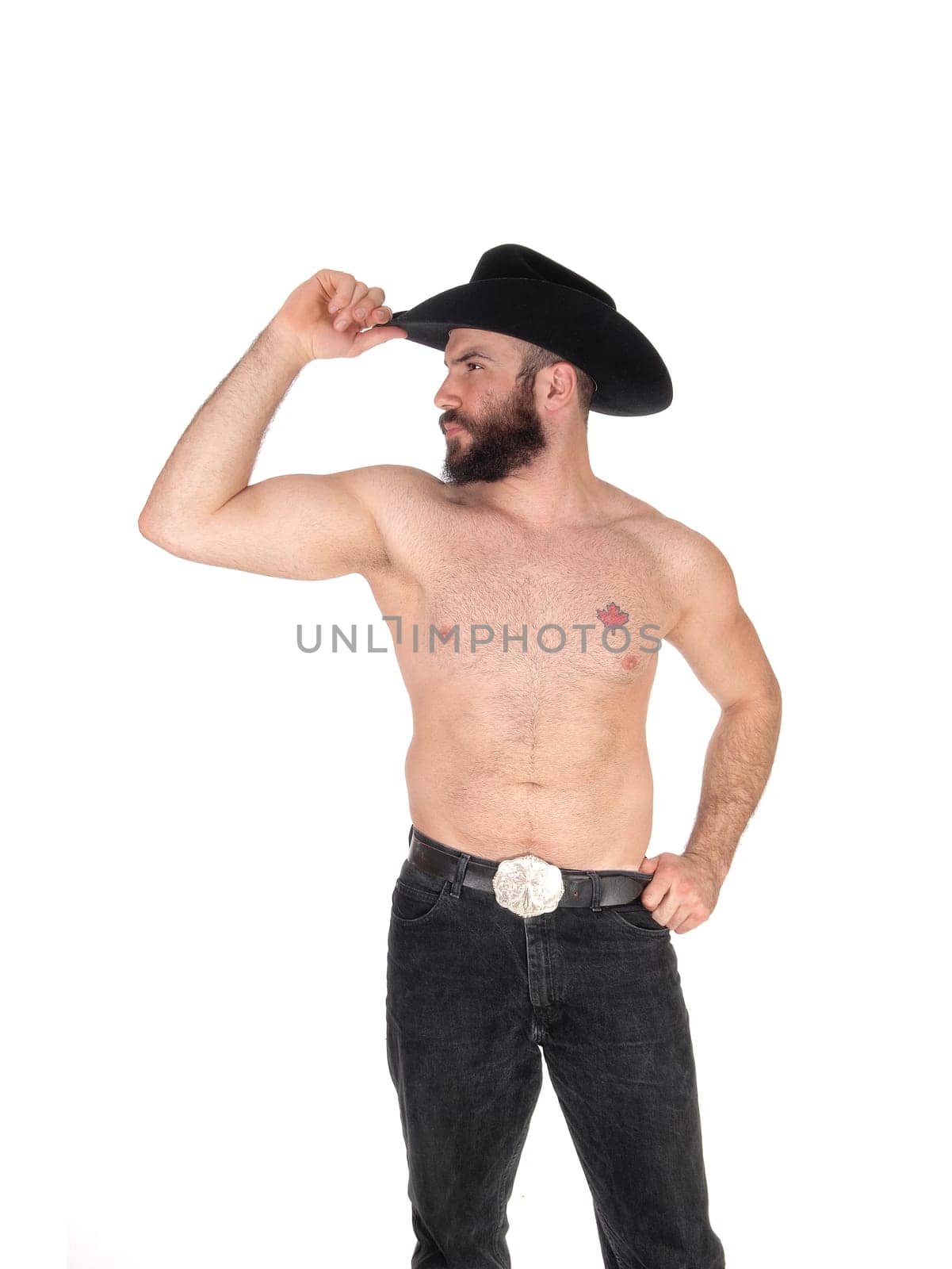 Young man standing shirtless, wearing a black cowboy hat and black.jeans with his muscular body, isolated for white background.