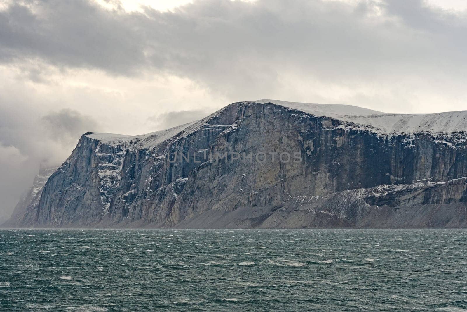 HIgh Cliffs Under Dramatic Clouds in the Sam Ford Fjordon Baffin Island in Nunavut, Canada