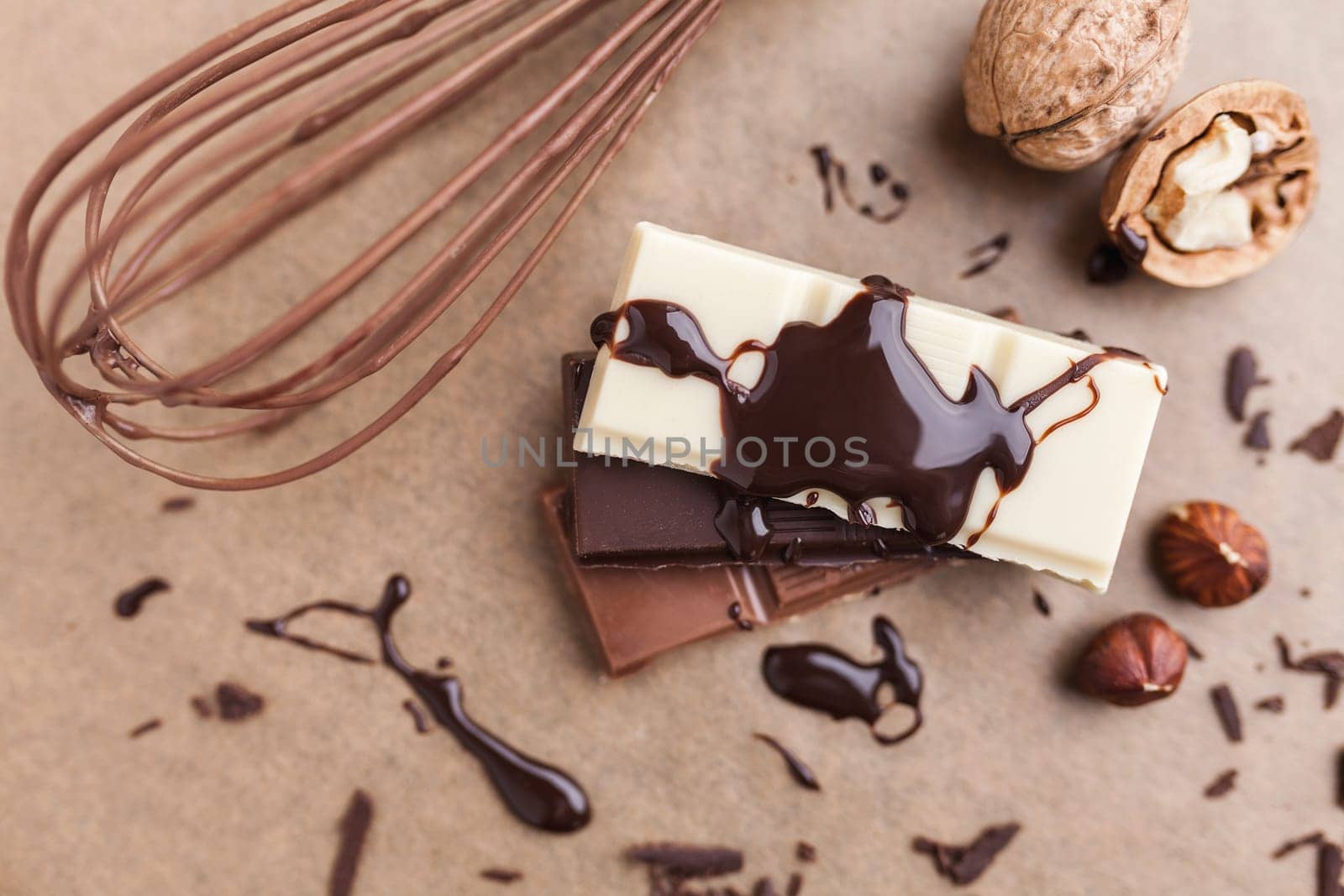 Variety of delicious chocolate bars with melted chocolate