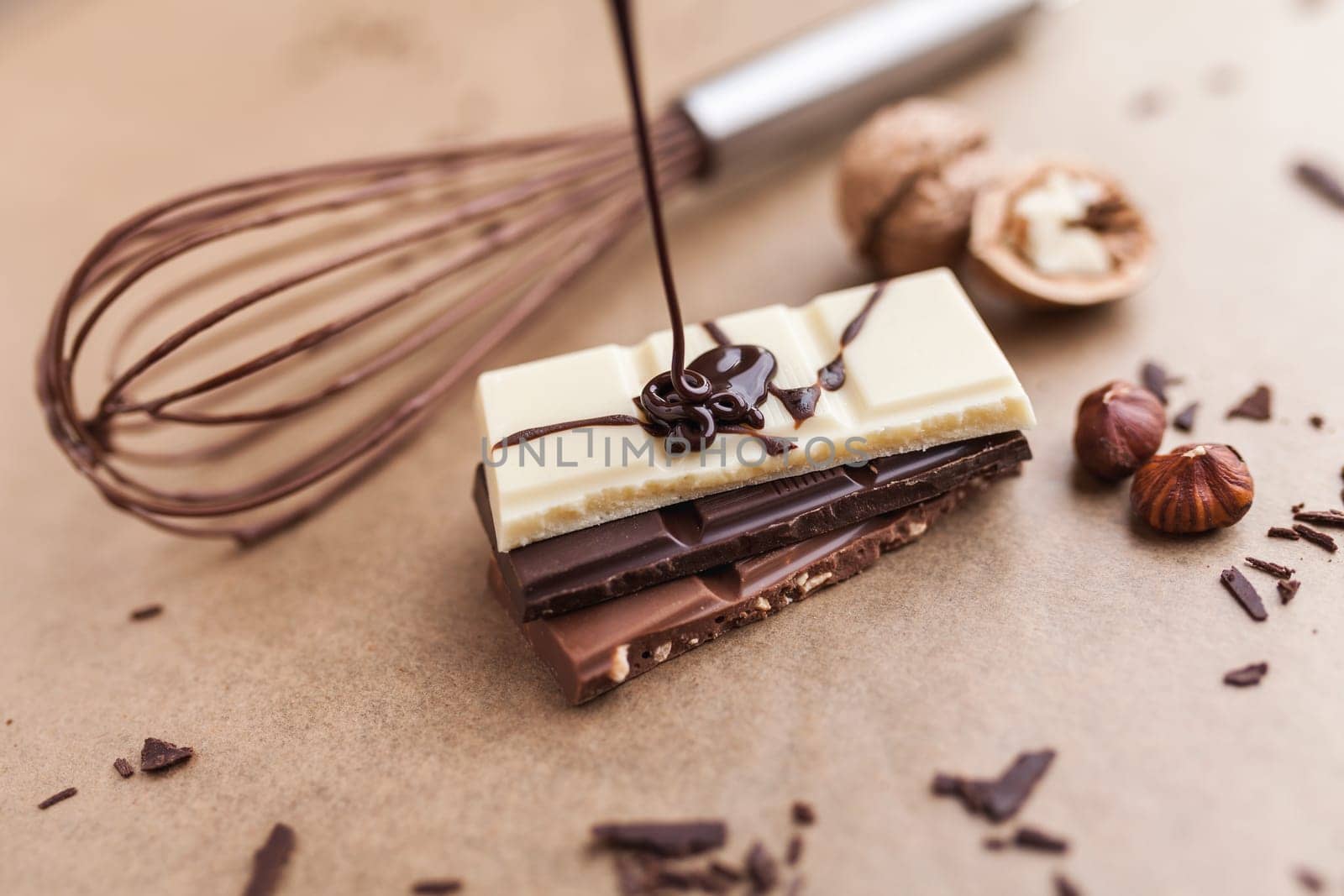Variety of delicious chocolate bars with melted chocolate