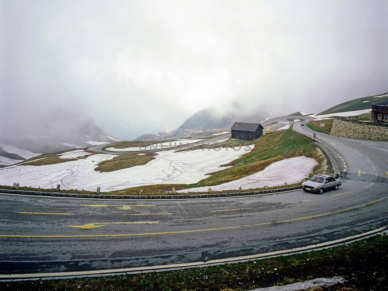 Fogy Alpine road with traffic in  Austria