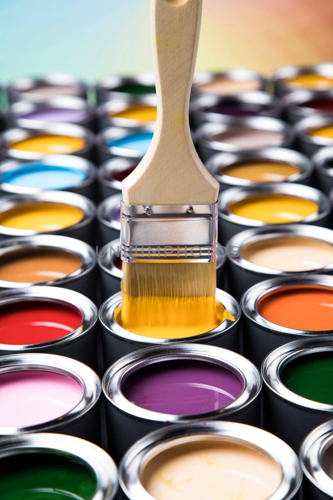 Metal tin cans with color paint and paintbrush