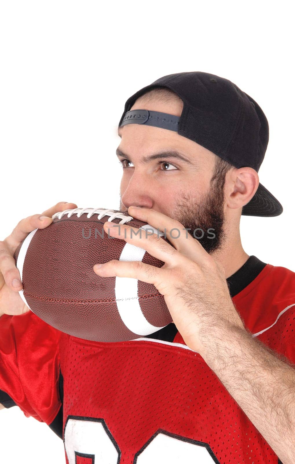 A close-up image of a football player in his jersey, holding his football.to his mouth, thinking, isolated for white background.
