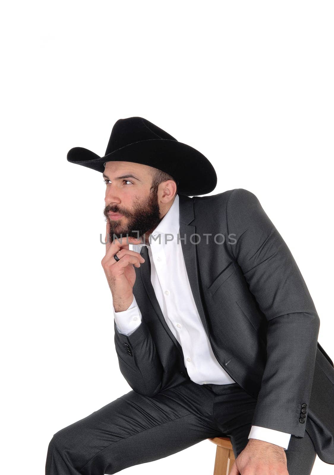 A close up portrait image of a handsome man in a suit and cowboy hat.with a beard and mustache, isolated for white background.