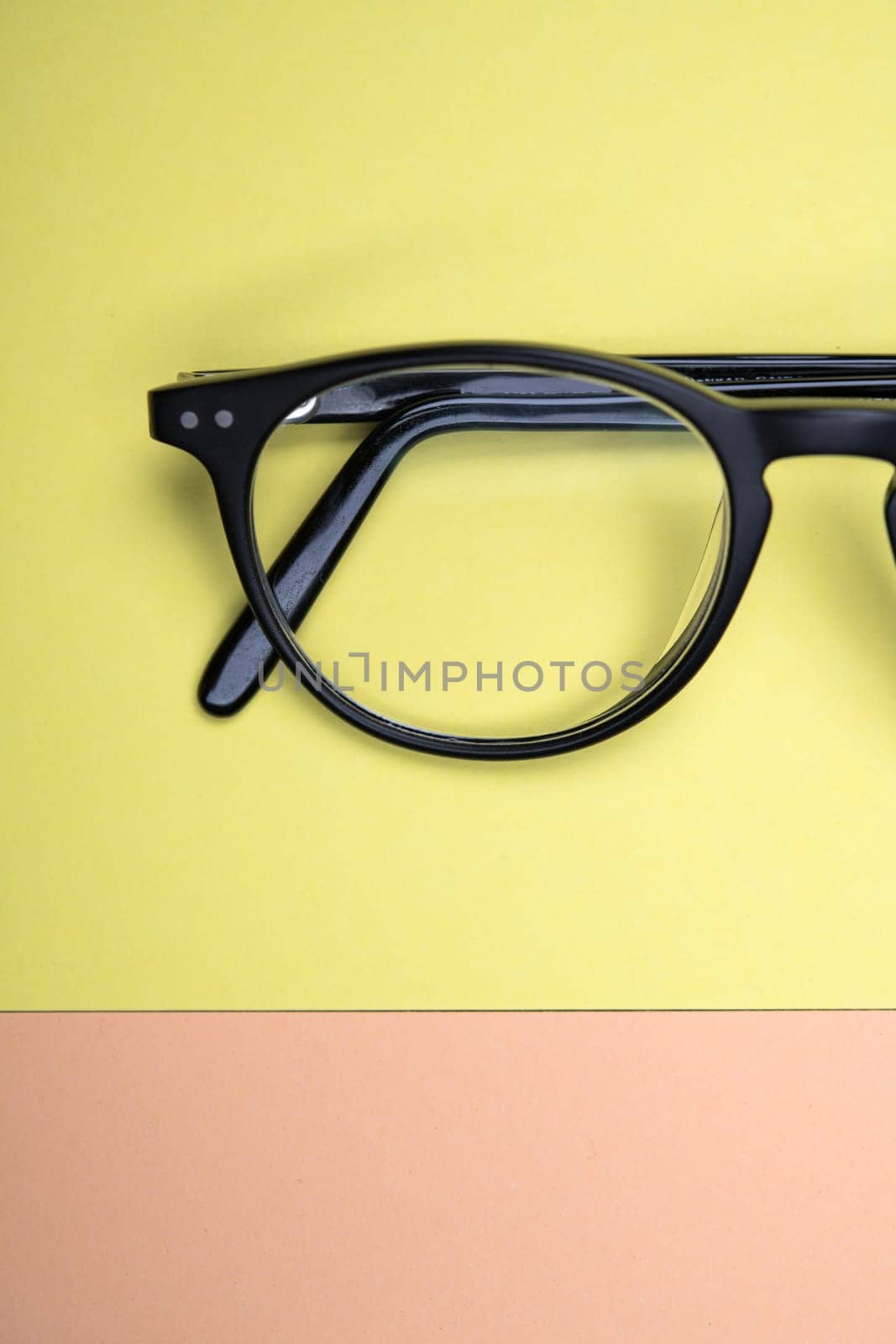 black glasses on yellow and orange ground from above