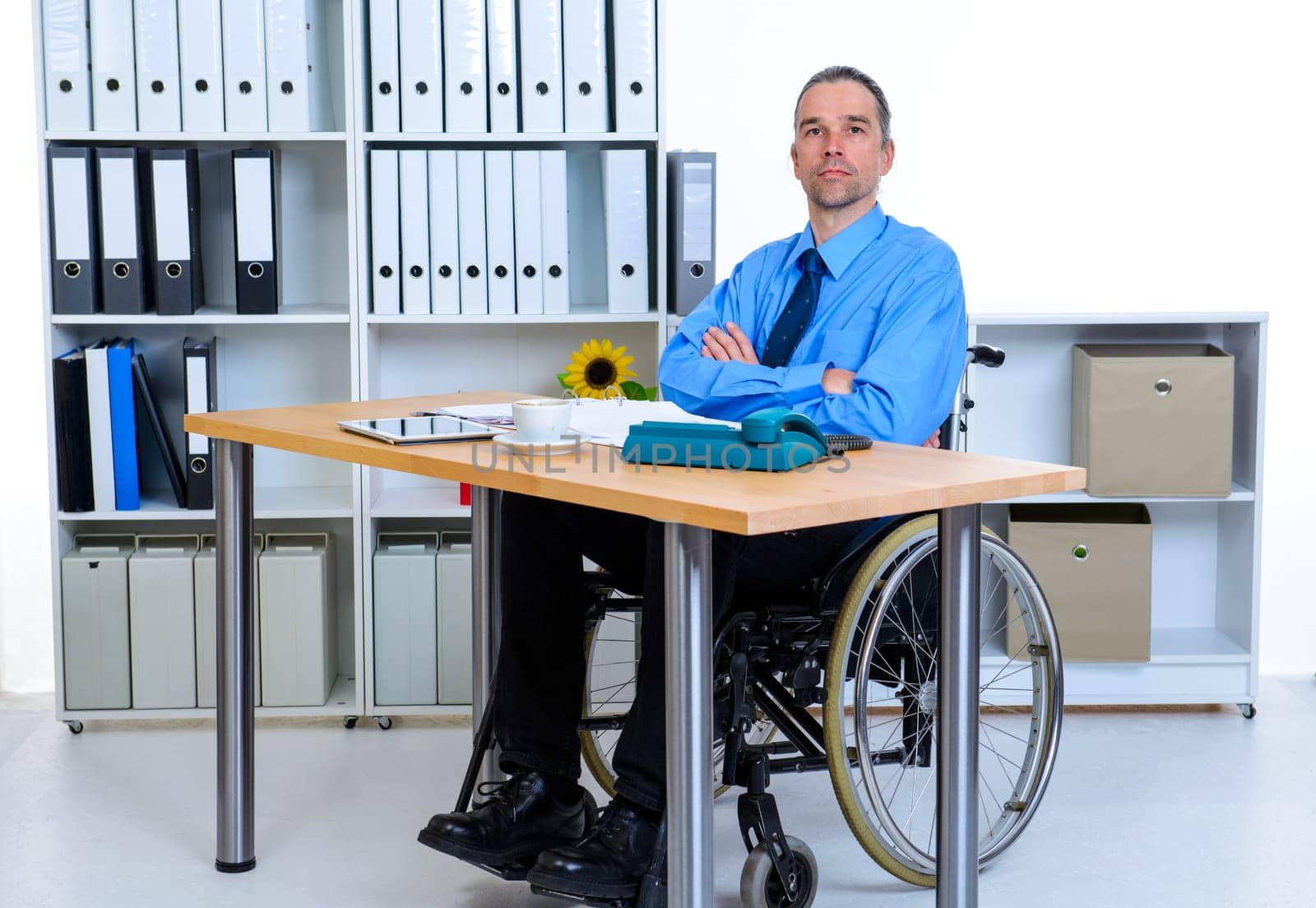 disabled business man in wheelchair is looking in to the camera