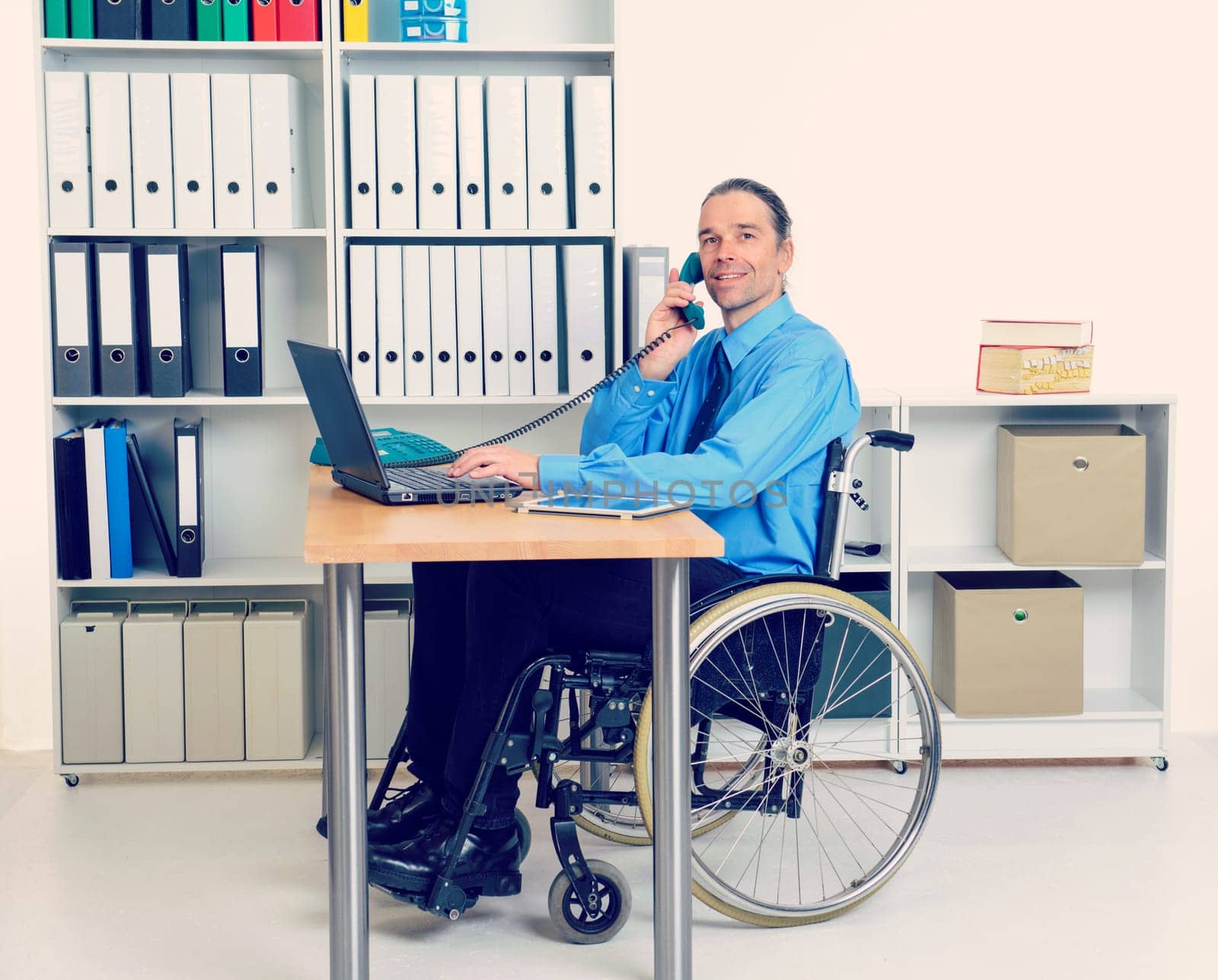 disabled business man in wheelchair is calling