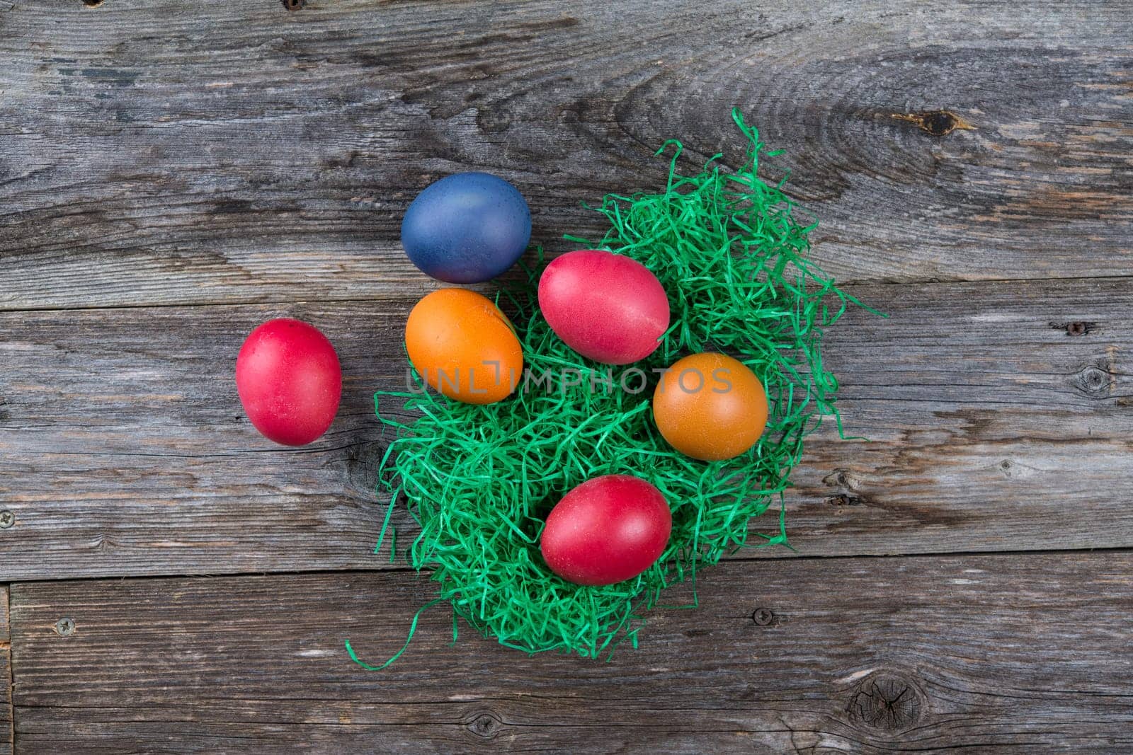 different easter eggs on gray wooden ground