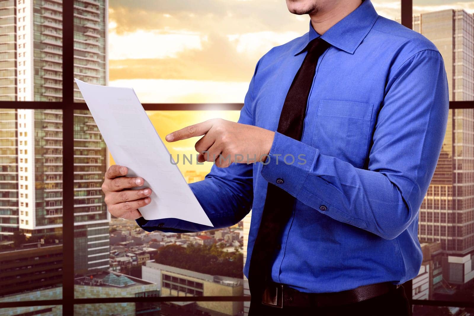 Businessman reading the business report in the office room