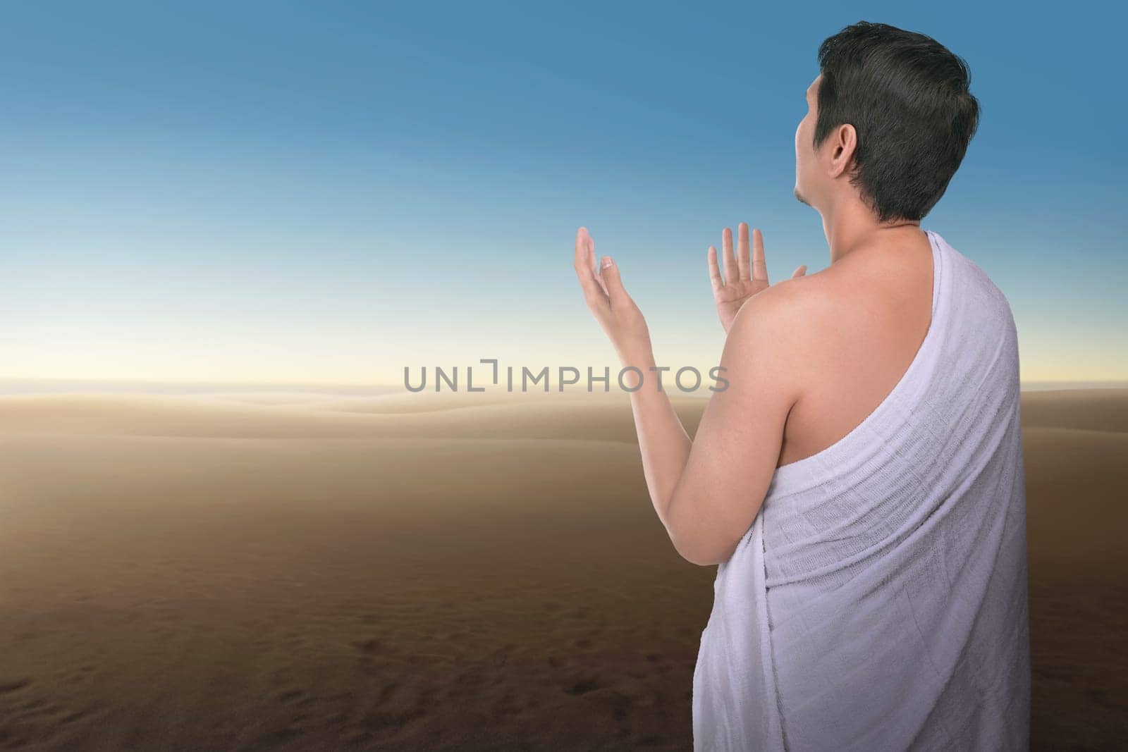 Religious asian hajj man praying with blue sky background