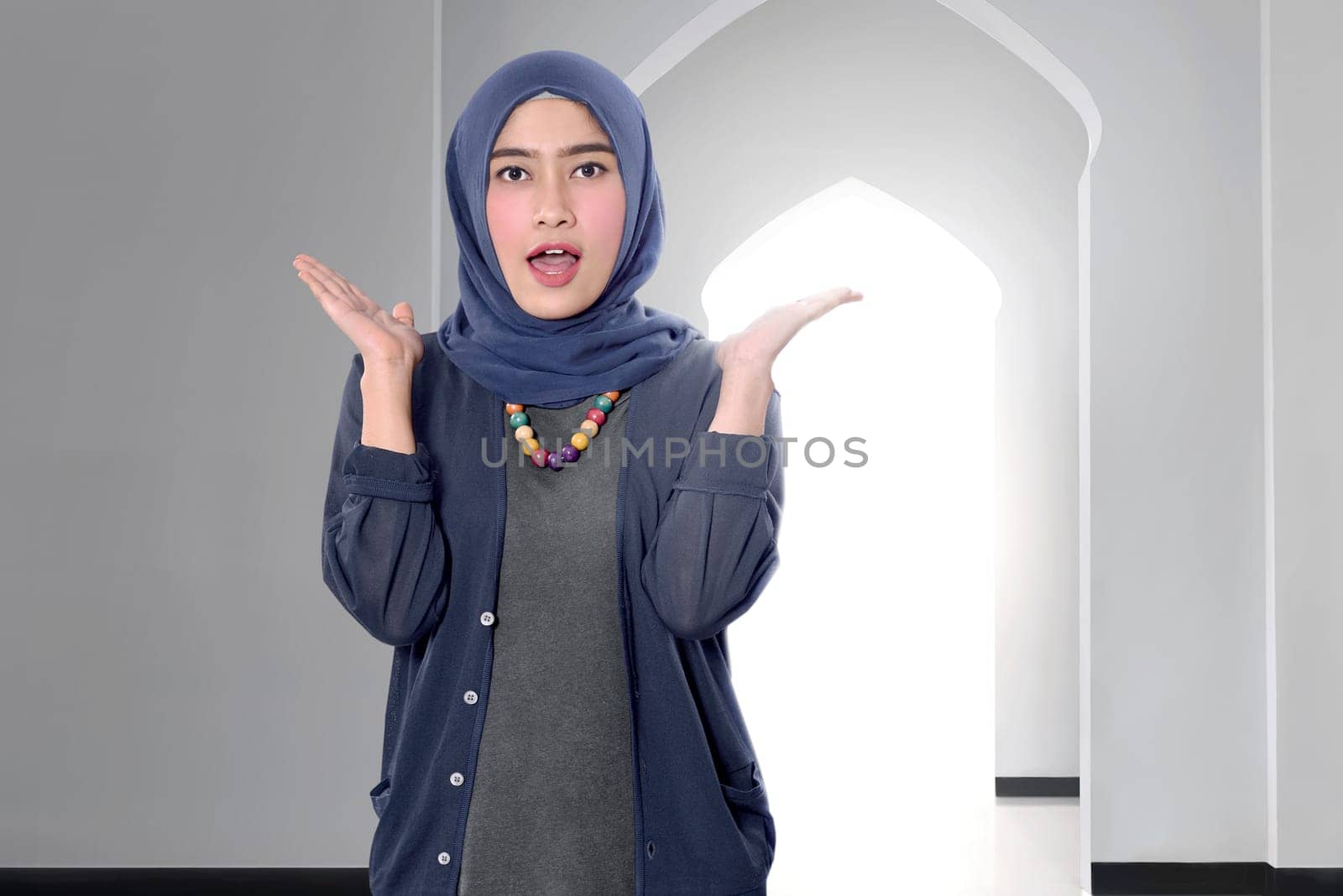 Funny asian female muslim woman with hijab on the mosque
