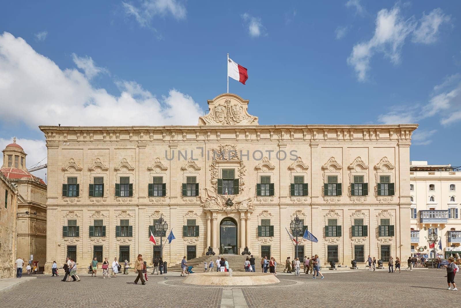 VALLETTA, MALTA - OCTOBER 30, 2017: People walking in front of the office of the prime minister of Malta, former building of The Auberge de Castille in Valleta, Malta.
