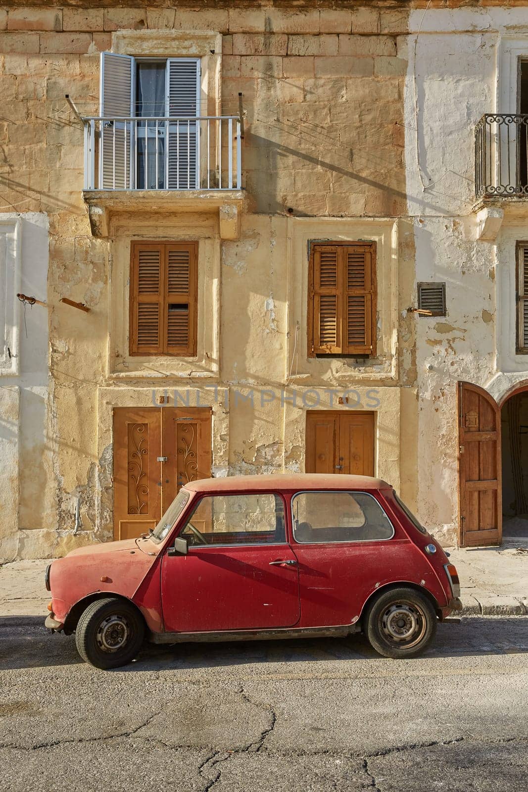 VALLETTA, MALTA - OCTOBER 30, 2017: Old vintage car in front of typical traditional house in Valletta in Malta.