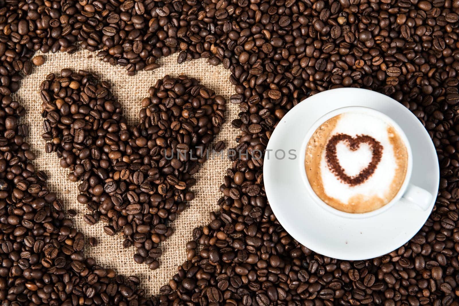 cappuccino with heart on a lot of coffee beans