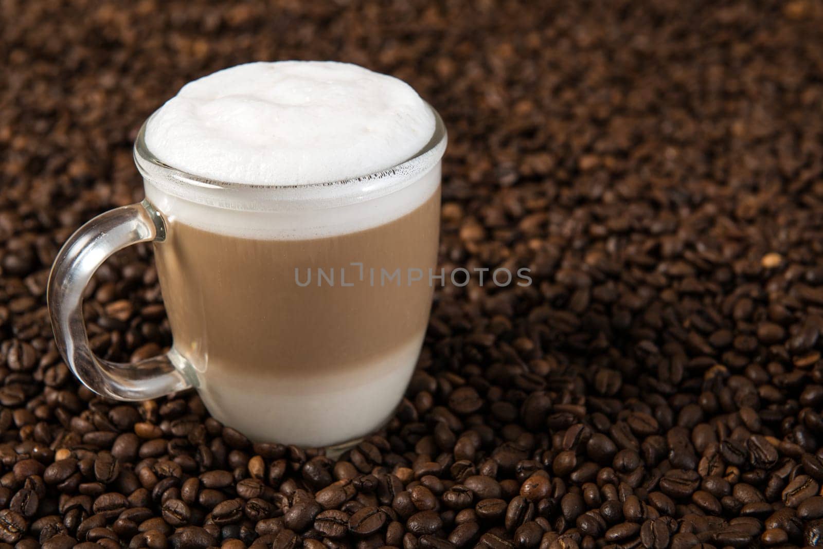 Latte Macchiato with heart on coffee beans