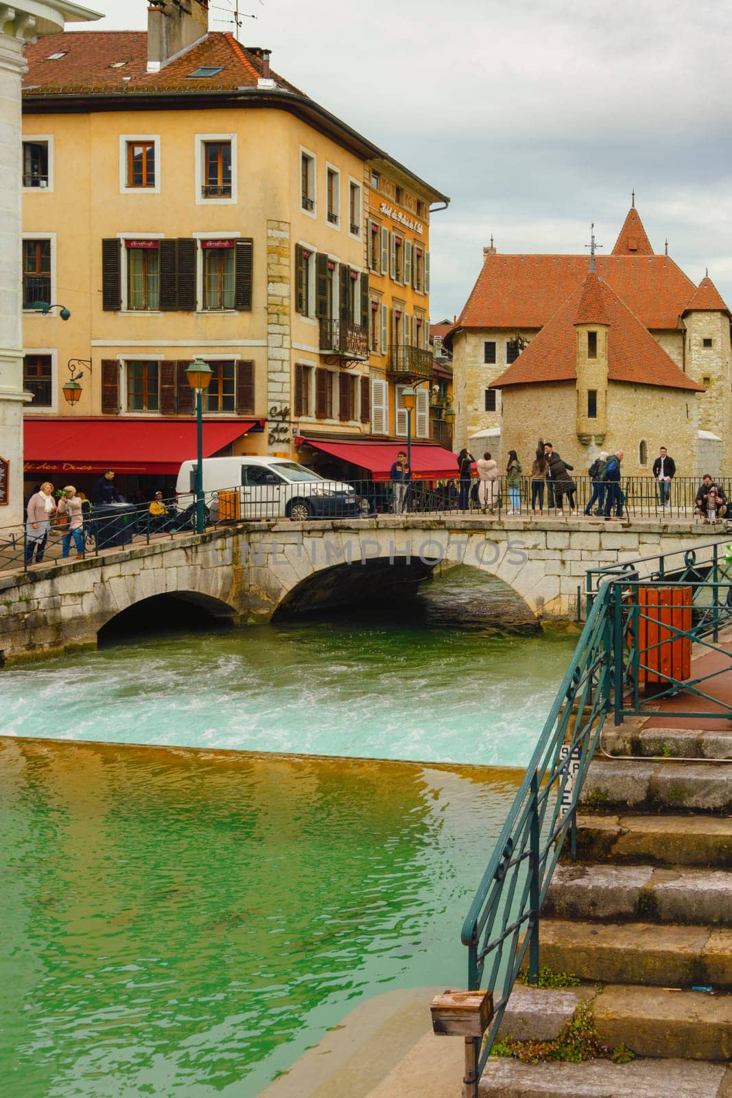 Annecy, France - May 01, 2018: Medieval old town and the tower of Palais de l'Isle castle on Thiou river in Annecy, Savoy, France