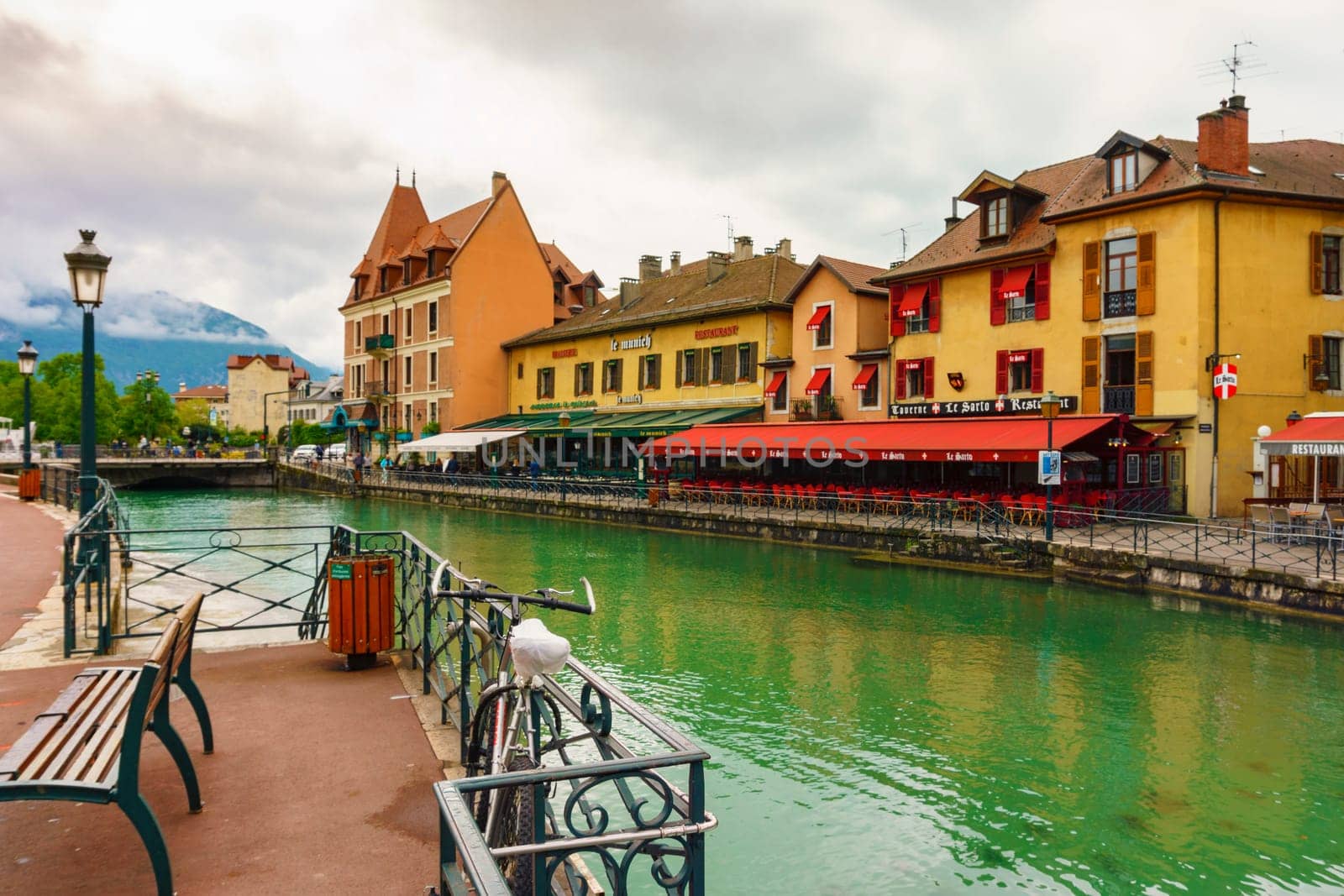 Annecy, France - May 01, 2018: Medieval old town and the tower of Palais de l'Isle castle on Thiou river in Annecy, Savoy, France