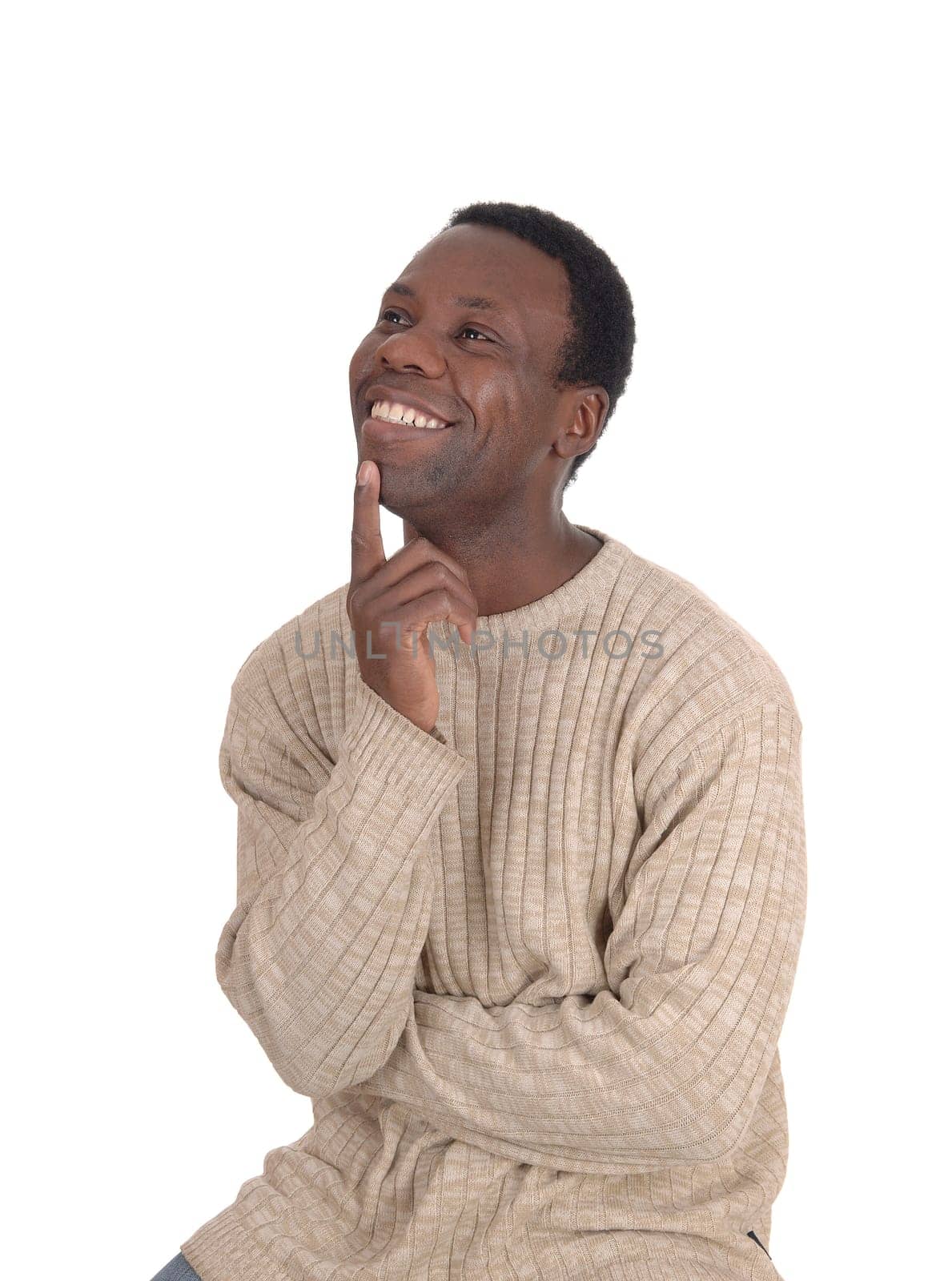 A young handsome African American man sitting in a sweater with.one finger on his chin, smiling of success, isolated over white.