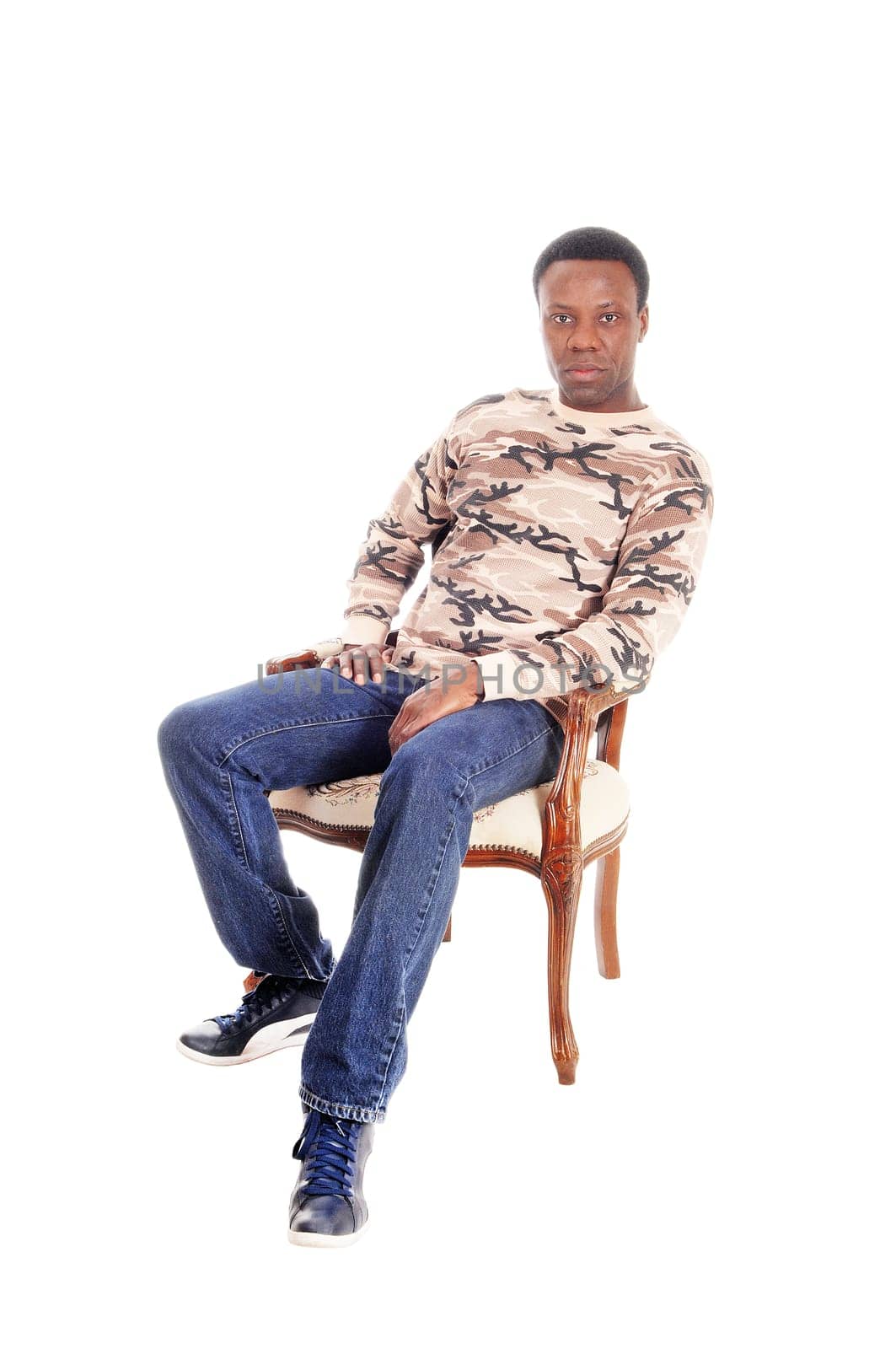 A full body image of a African American man in jeans and t-shirt.sitting on chair and relaxing, isolated for white background.