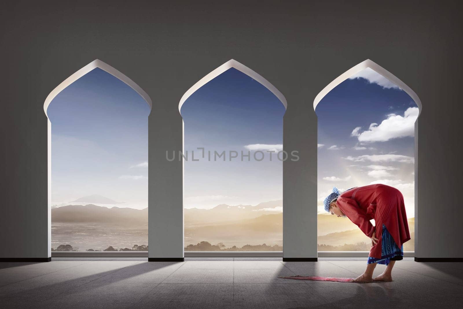 Elderly asian muslim man praying inside the mosque