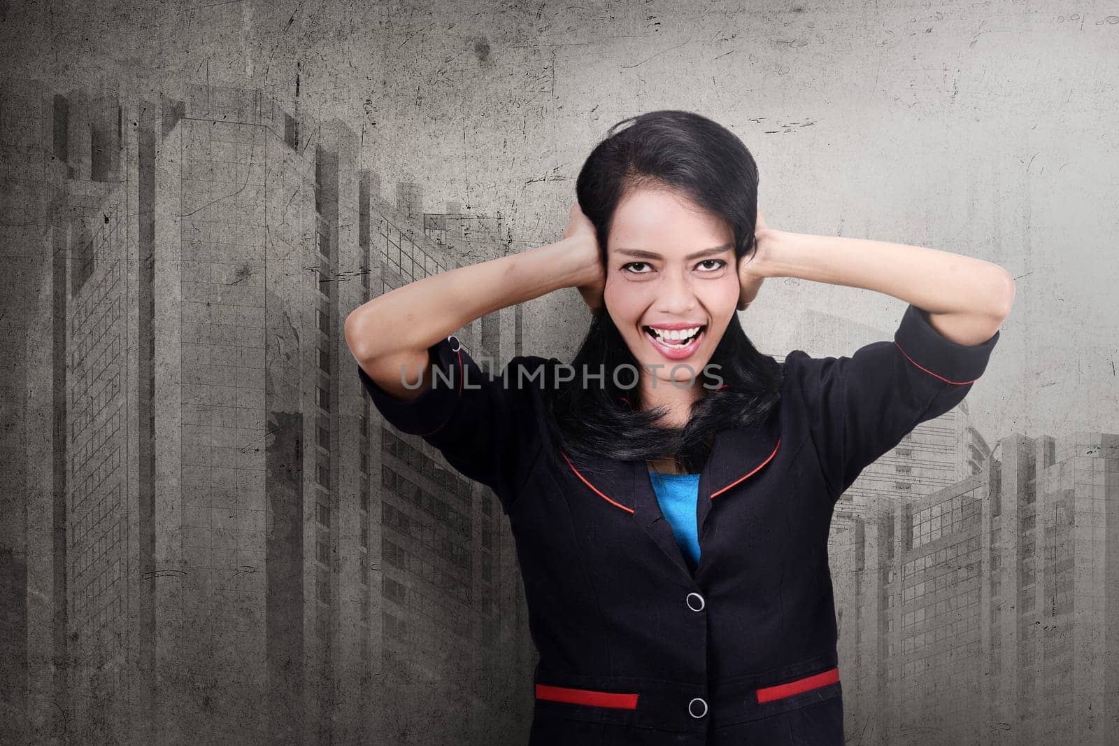 Pretty asian business woman covering her ears over abstract background