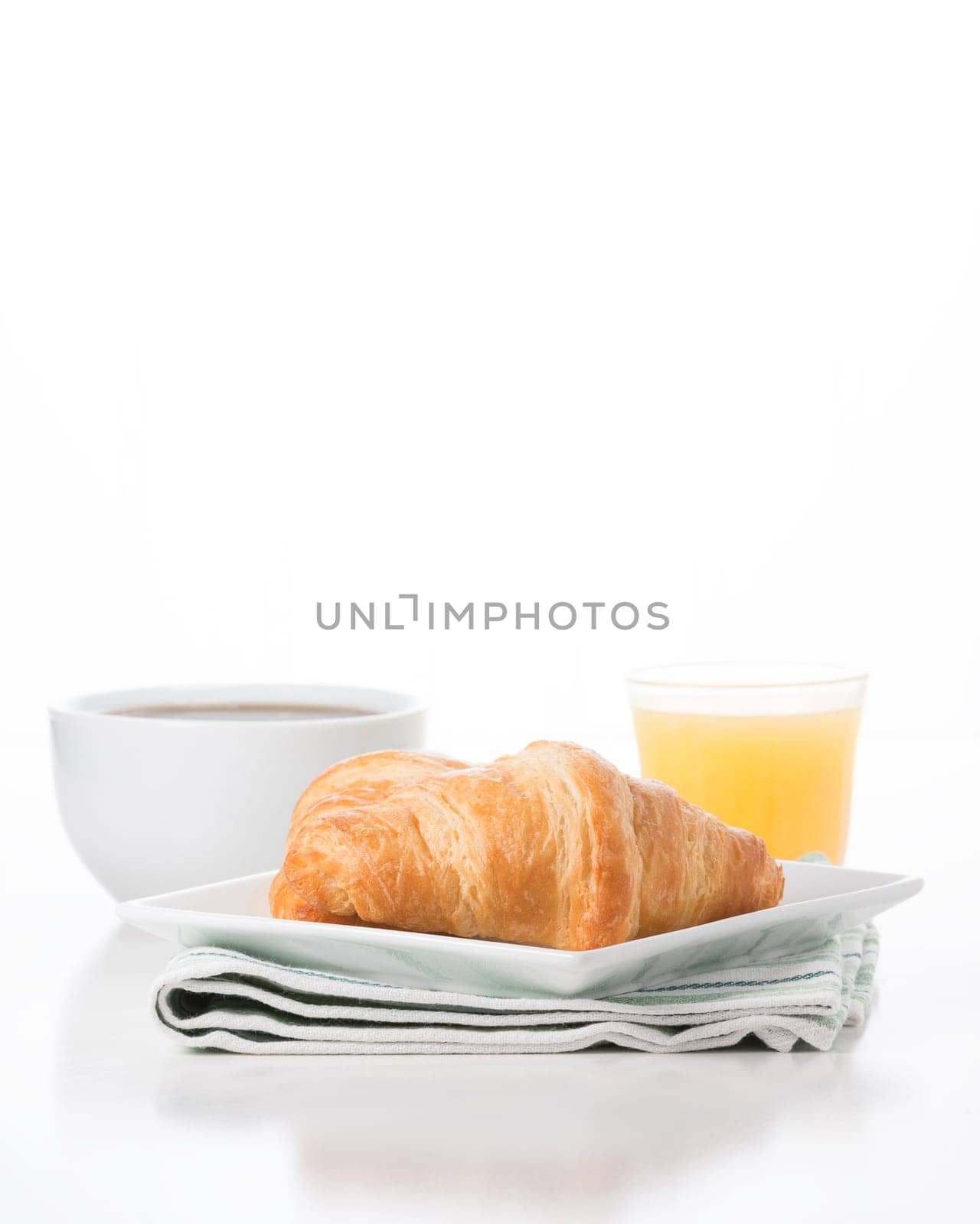 Fresh croissants served with coffee and orange juice.