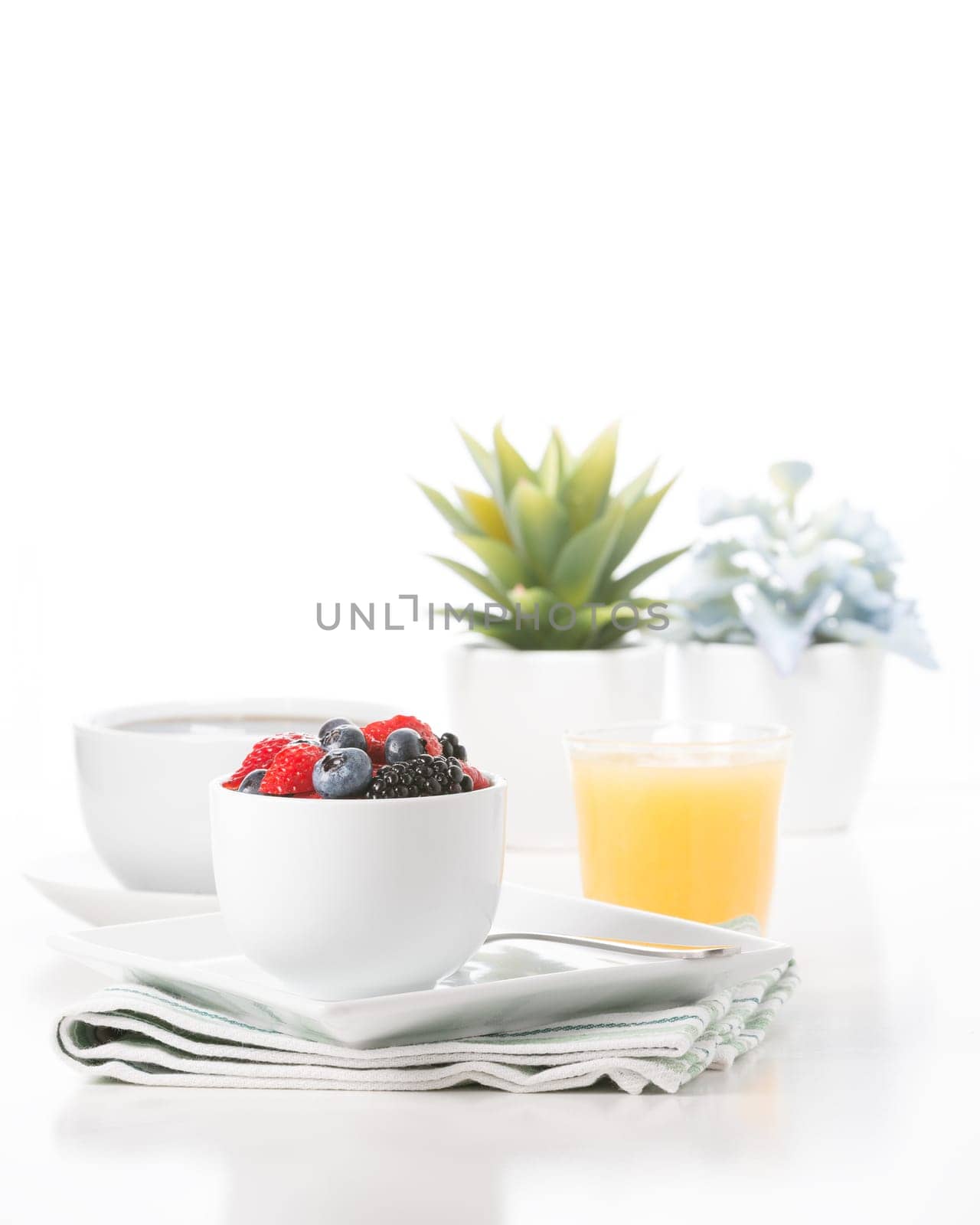 Small bowl of fresh berries served with coffee and juice.