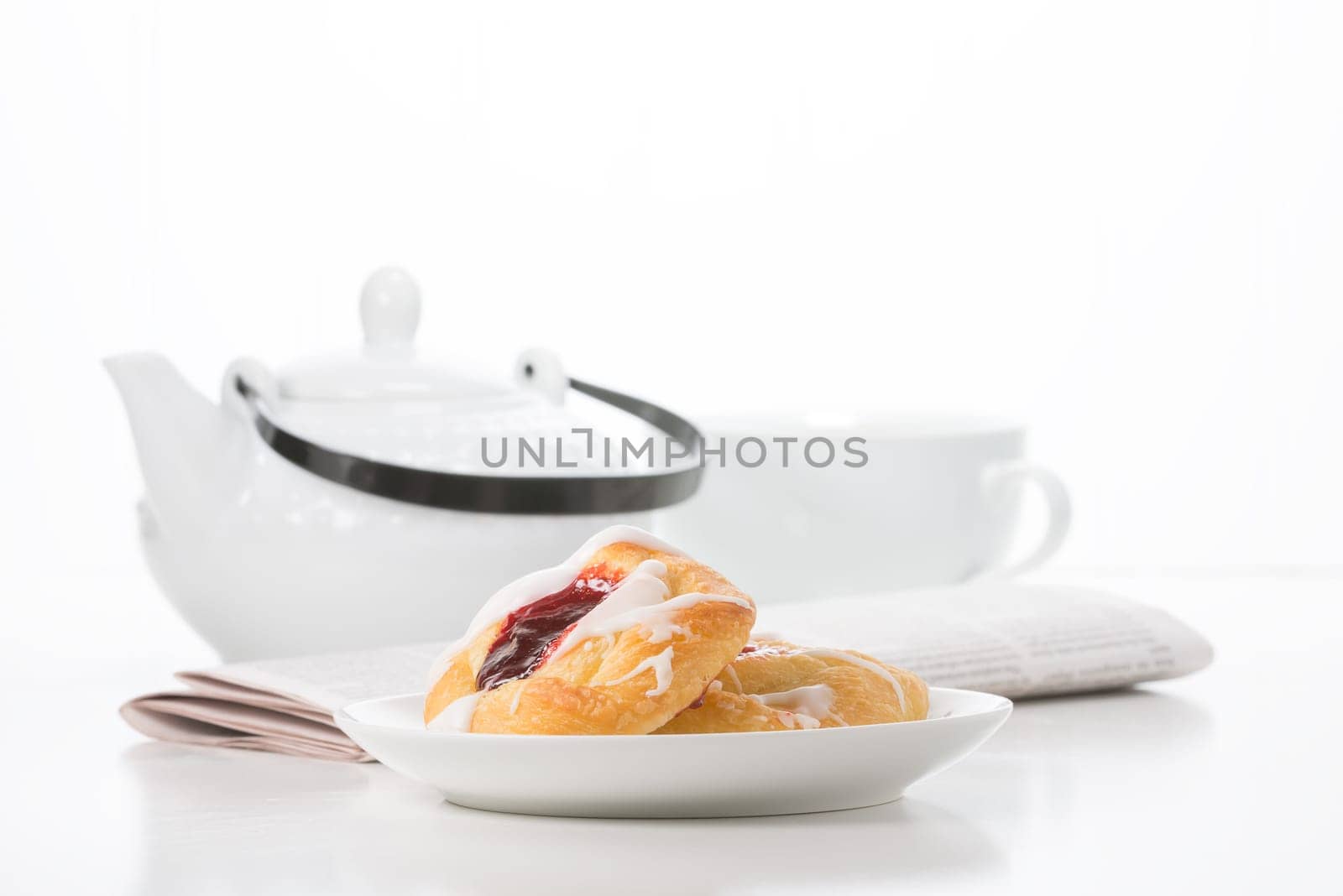 Morning breakfast of raspberry danish and coffee.
