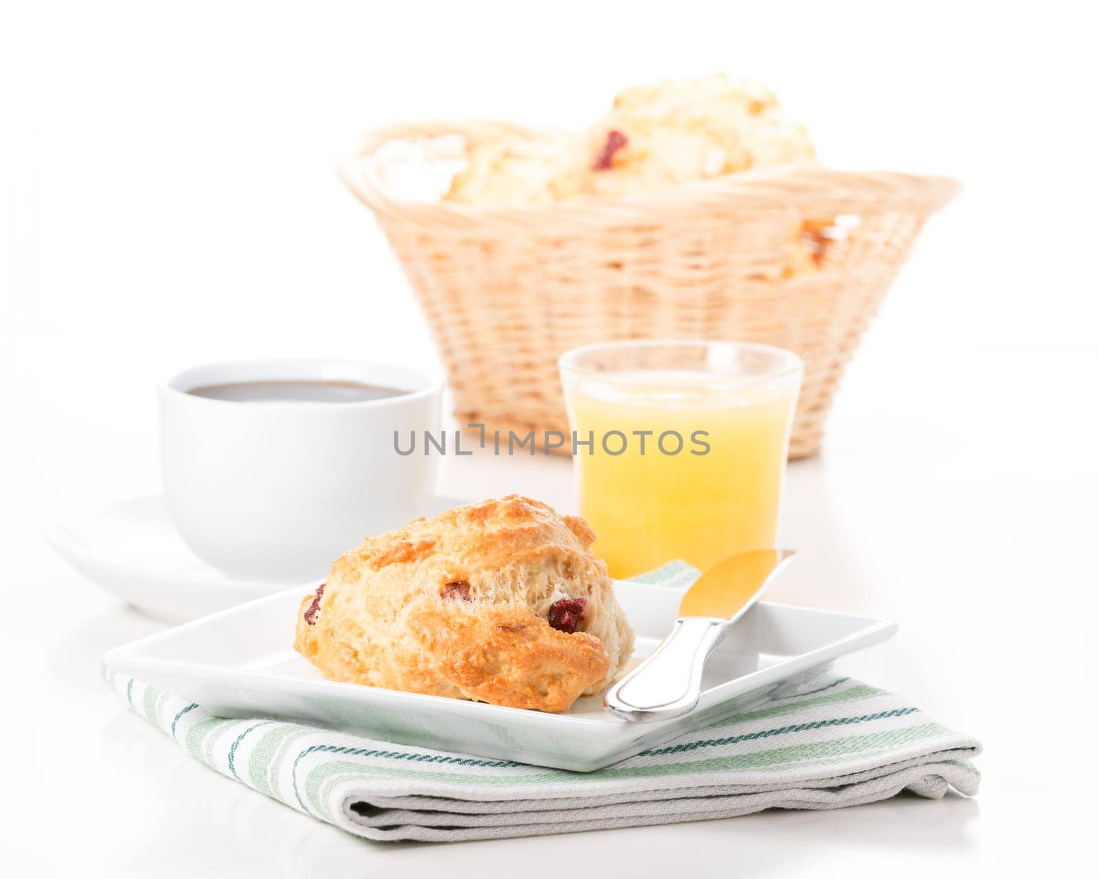 Fresh cranberry lemon scones served with coffee and juice.