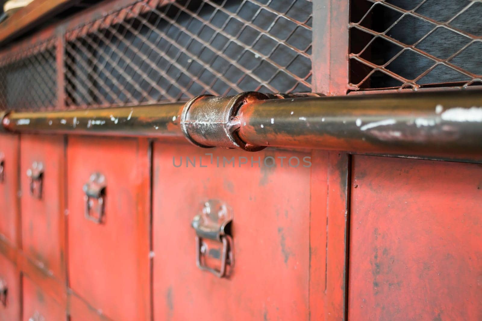 Red metal antique distressed cabinet with door pulls, stock photo