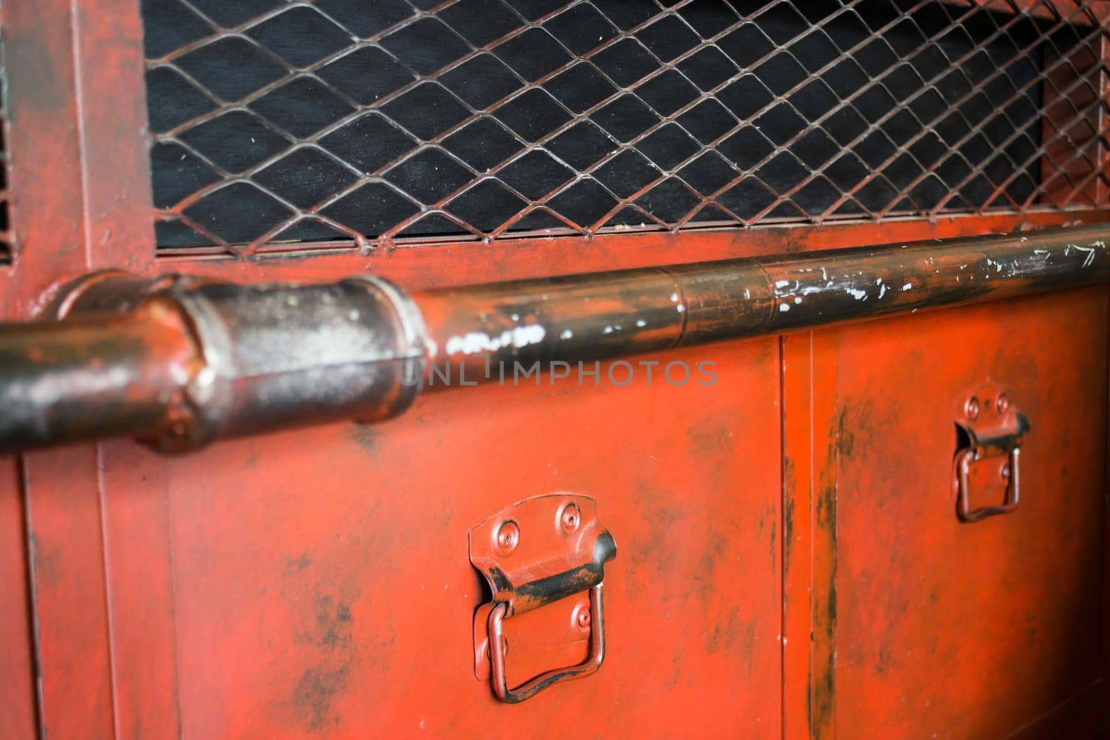 Red metal antique distressed cabinet with door pulls, stock photo