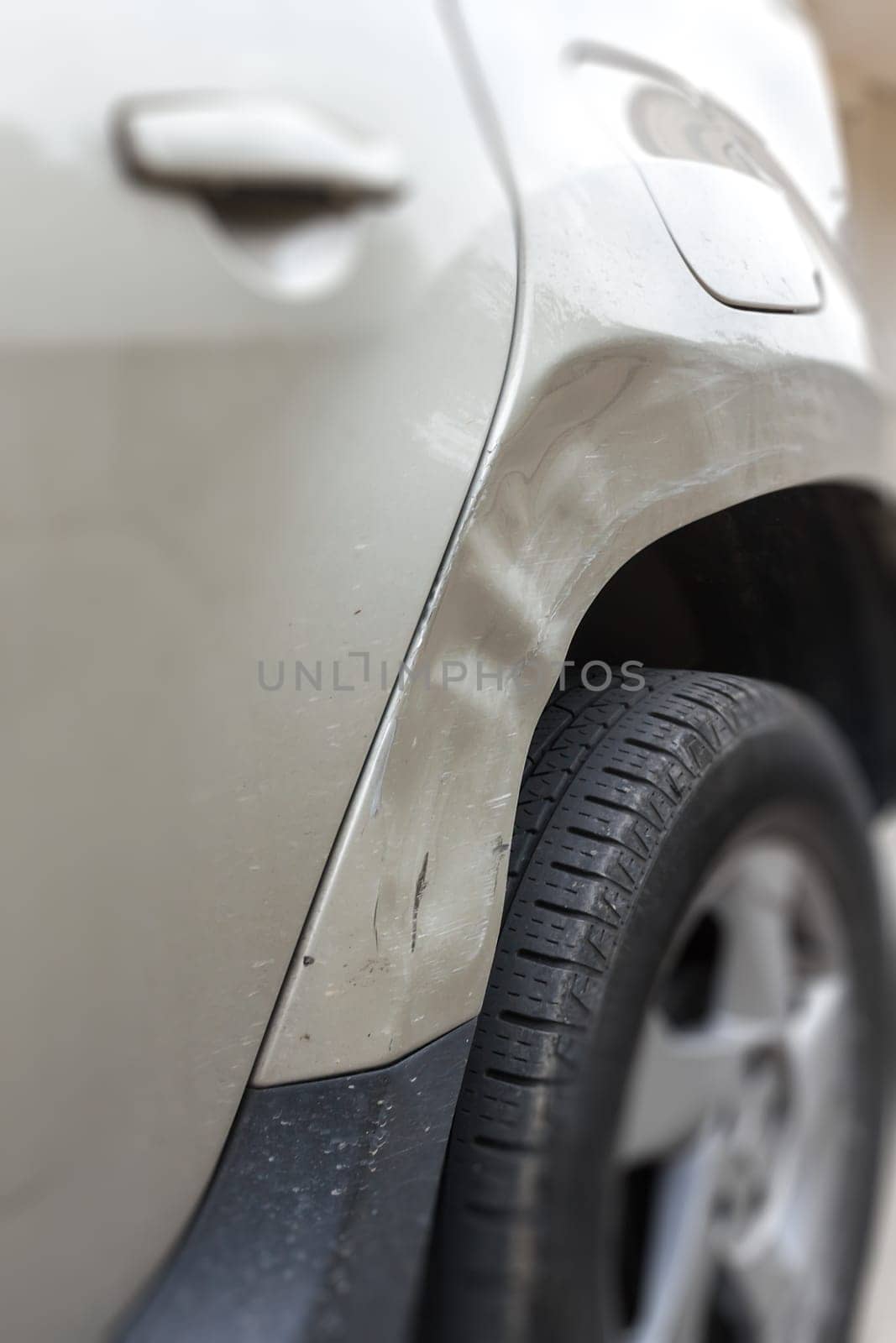 Closeup Dented car. Side body of car was damaged by accident in traffic.