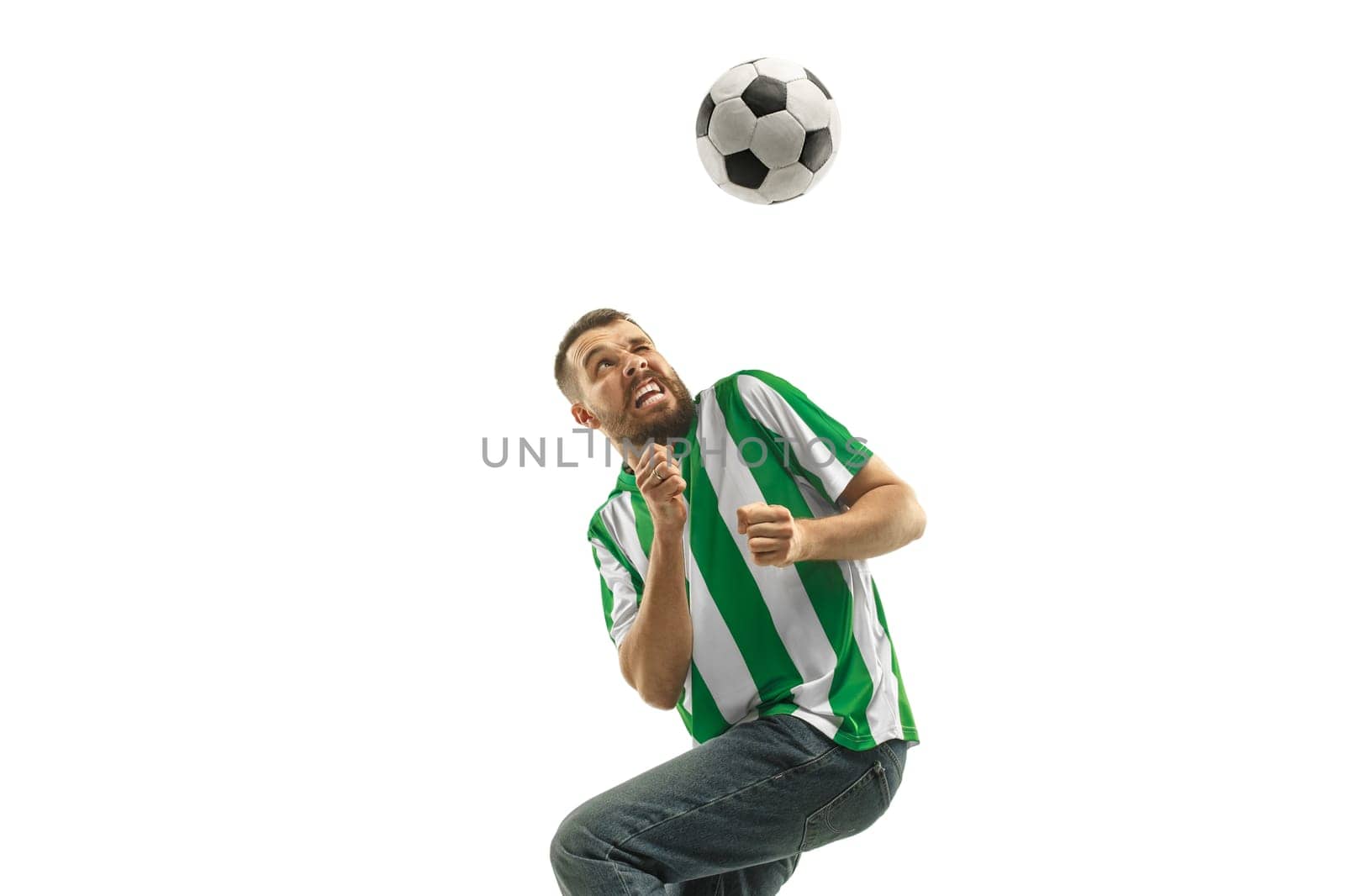 Irish fan celebrating on white background. The young man in soccer football uniform as winner with ball isolated at white studio. Fan, support concept. Human emotions concept.