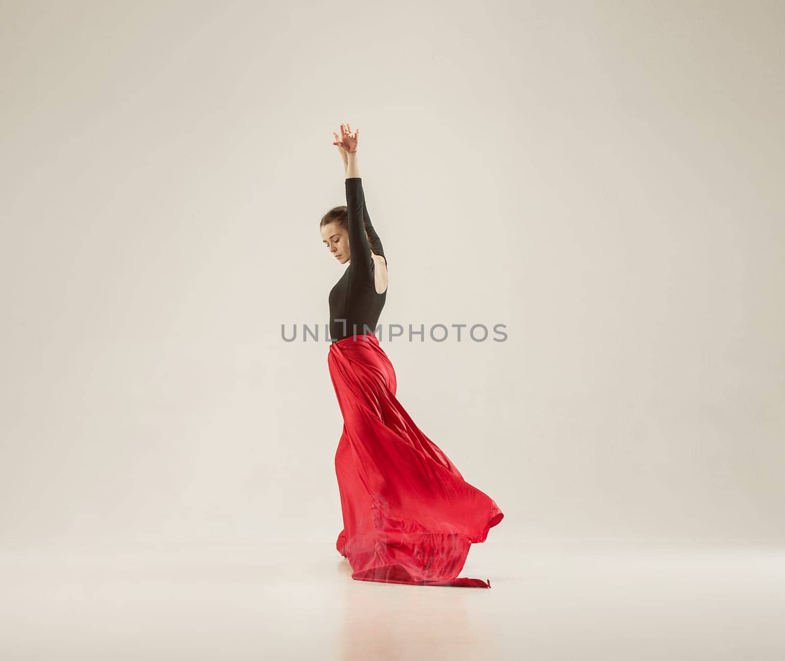 Modern ballet dancer exercising in full body on white studio background. Ballerina or female dancer with silk fabric dancing on white studio background. Caucasian model on pointe shoes