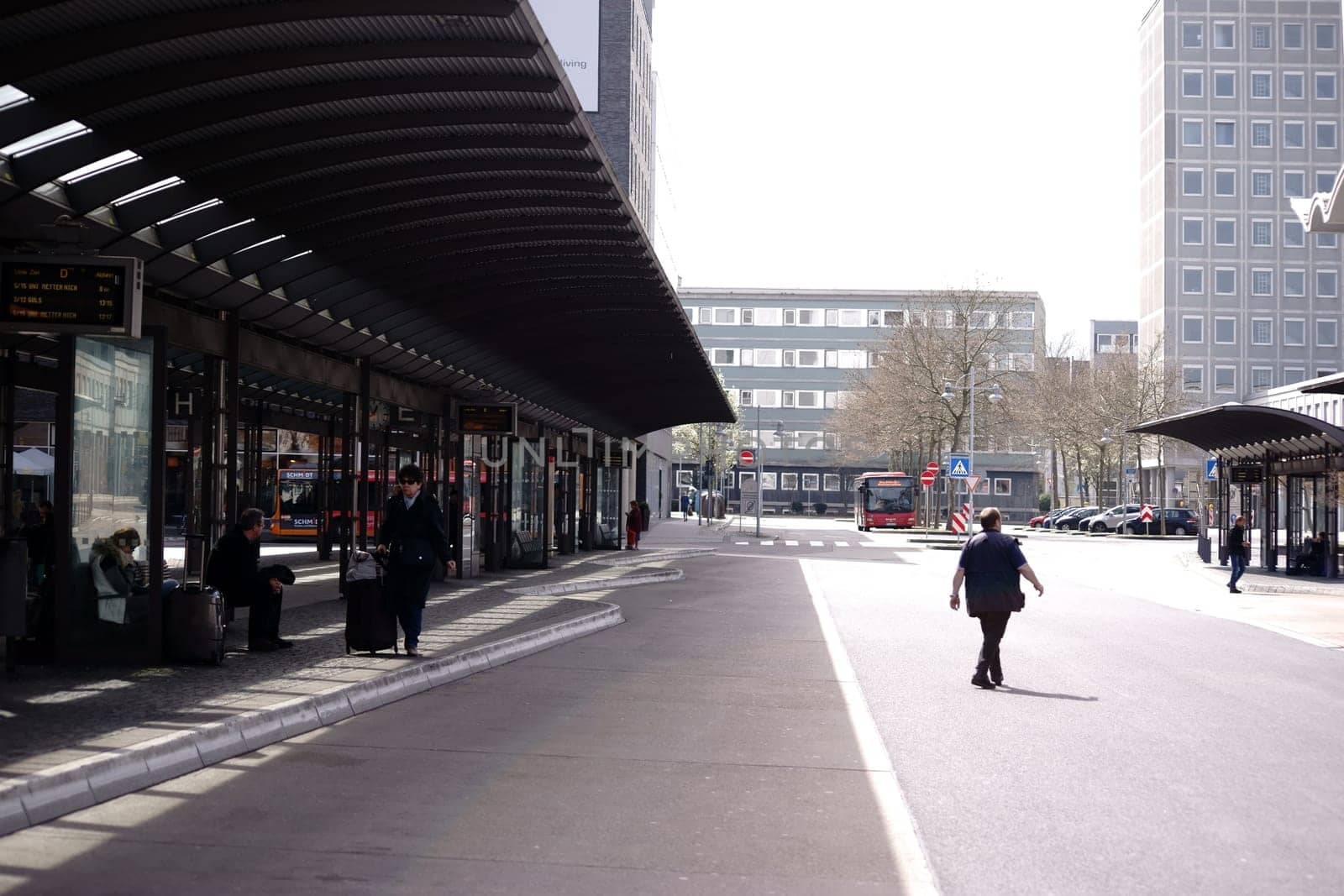 Koblenz,Germany – April 08,2018: People sit under the covered shelters of the bus station in the city center on April 8,2018 in Koblenz.