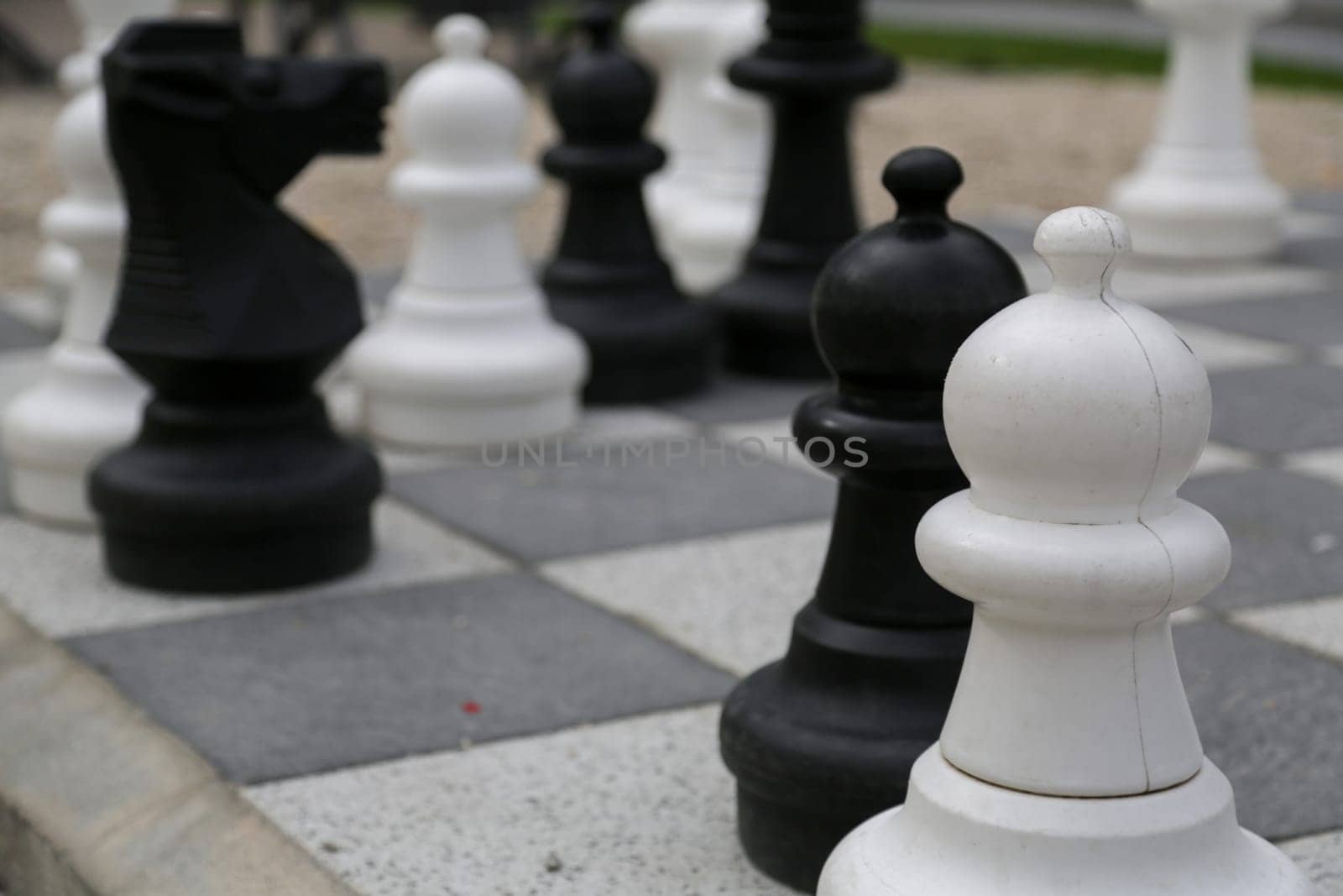 Black and white king on a chess board in open air