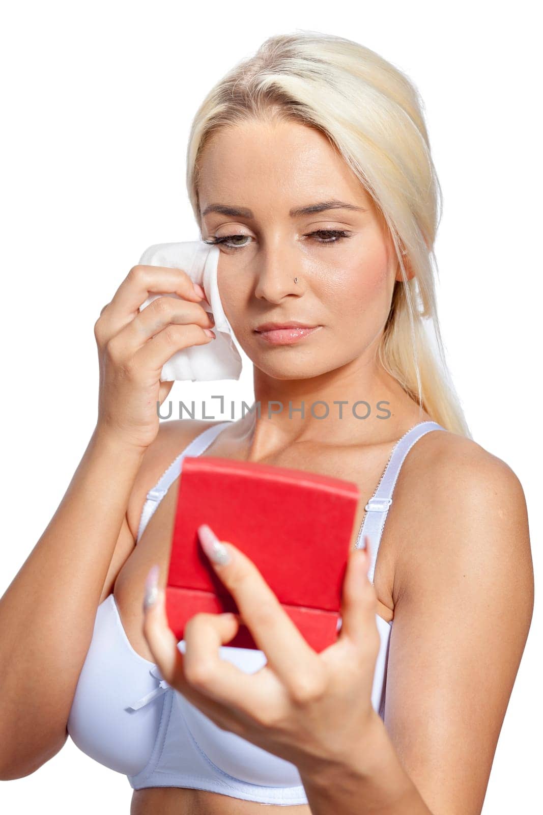 Young woman clean face and eyes with wet wipes, holding mirror, remove make-up, body breast lingerie