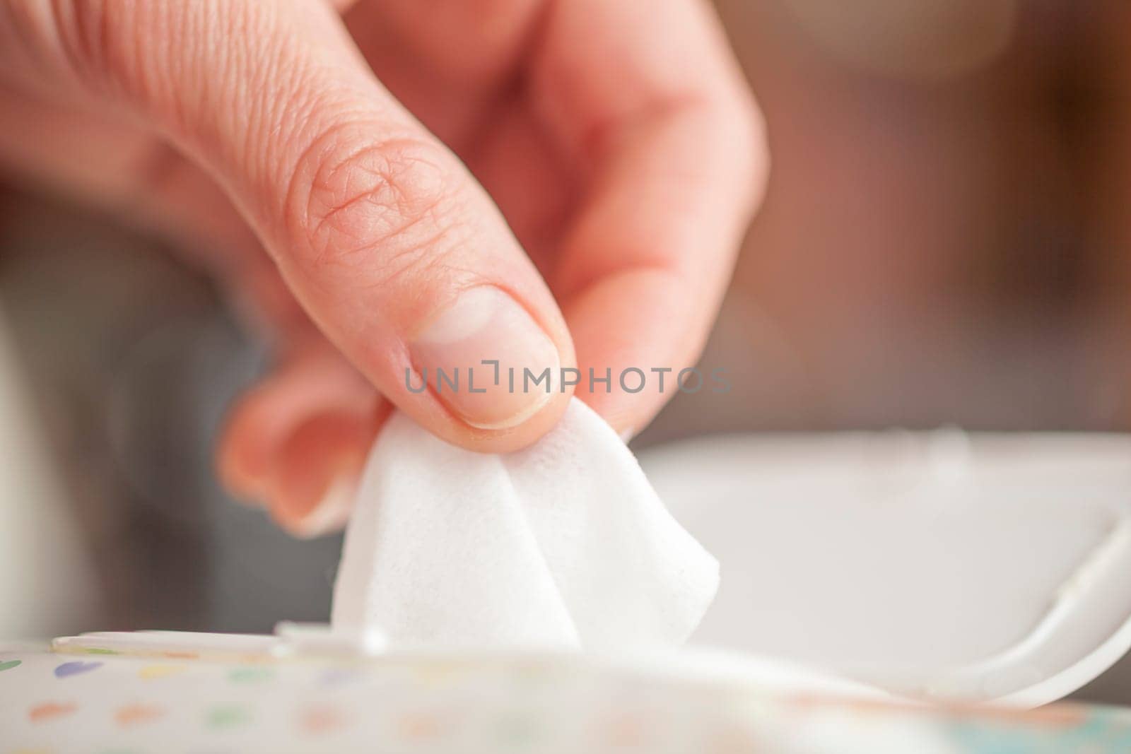 Hand picked a wet wipes in package box, Wet wipes in a woman's hand