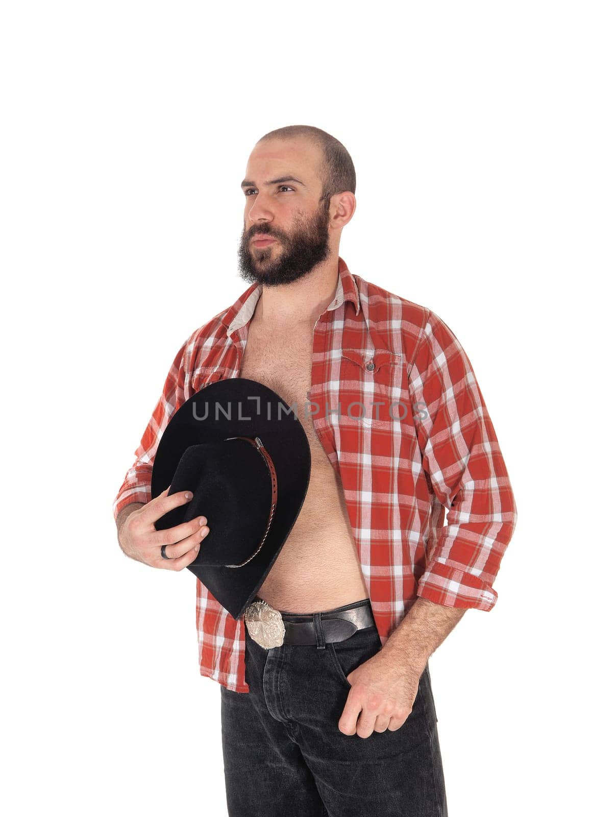 A close up image of a young man in a open checkered shirt wearing a.cowboy hat and black jeans, isolated for white background.
