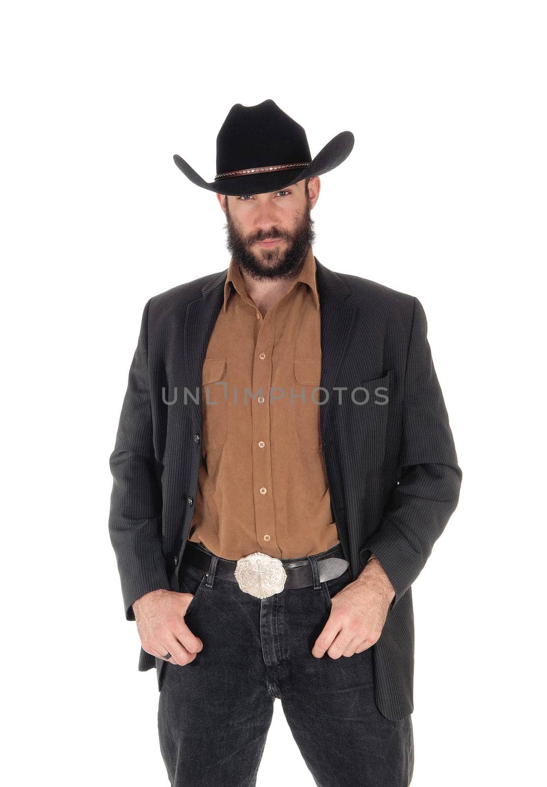 A young serious looking man in a gray blazer and black cowboy hat.with his hands in his pocket, isolated for white background.