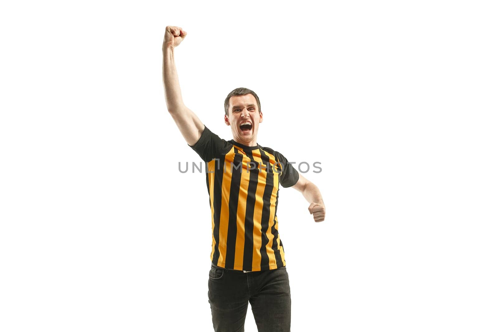The young Belgian fan celebrating on white background. The young man in soccer football uniform as winner isolated at white studio. Fan, support concept. Human emotions concept.