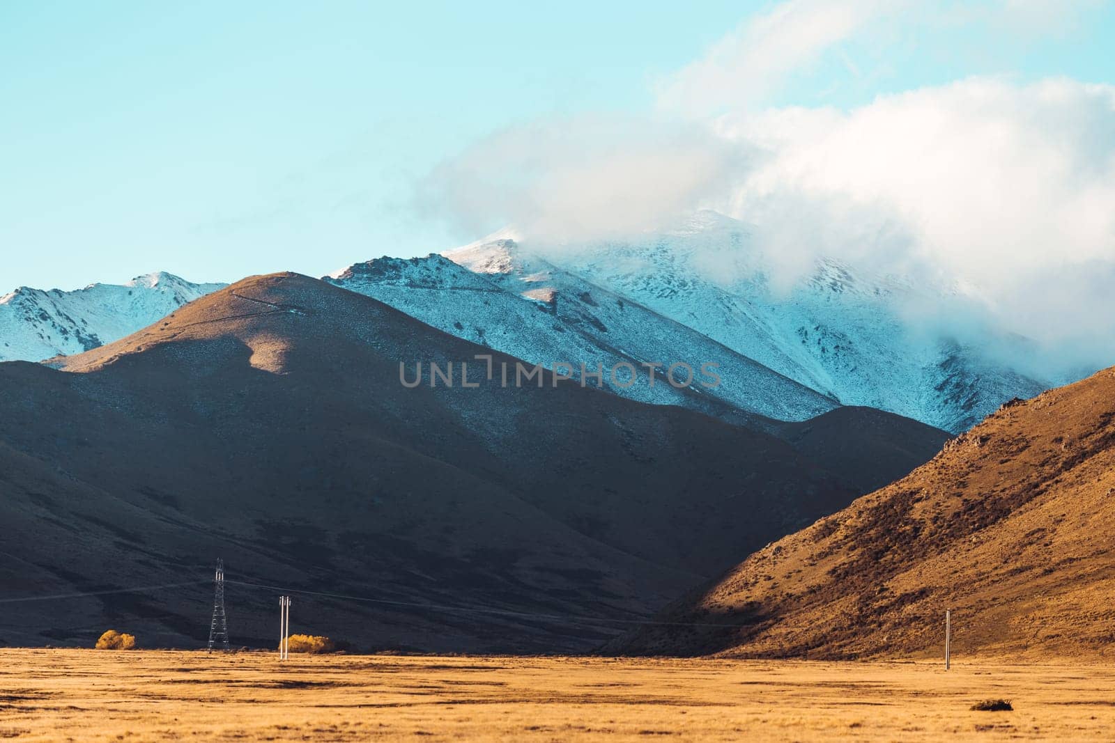 Road travel in the green mountains of New Zealand view from car window. Scenic peaks and ridges. Beautiful background of amazing nature.