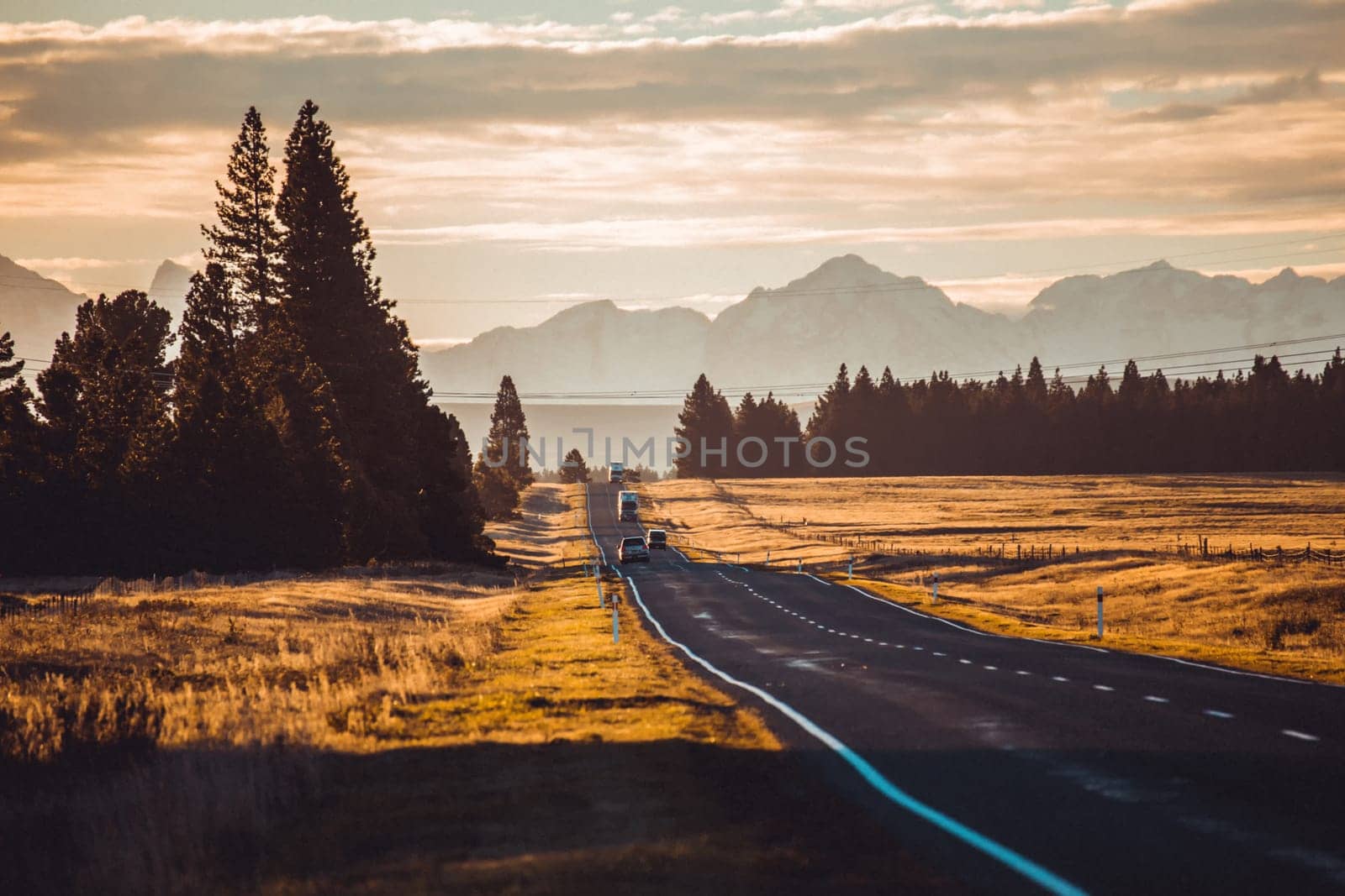 Road travel in the green mountains of New Zealand view from car window. Scenic peaks and ridges. Beautiful background of amazing nature.
