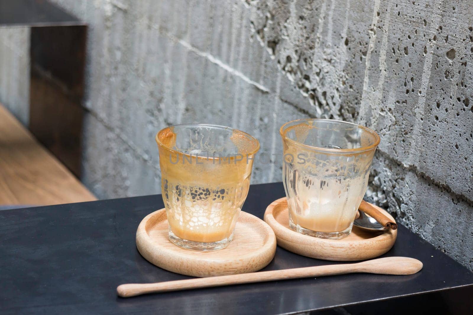 Finished drink of latte coffee on wooden saucer, stock photo