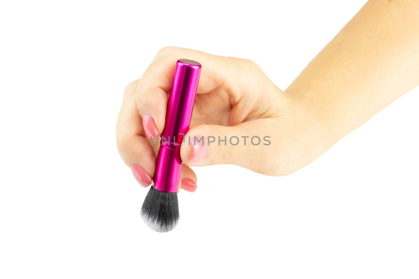 Closeup of female hand is holding professional makeup brush. Concept beauty.